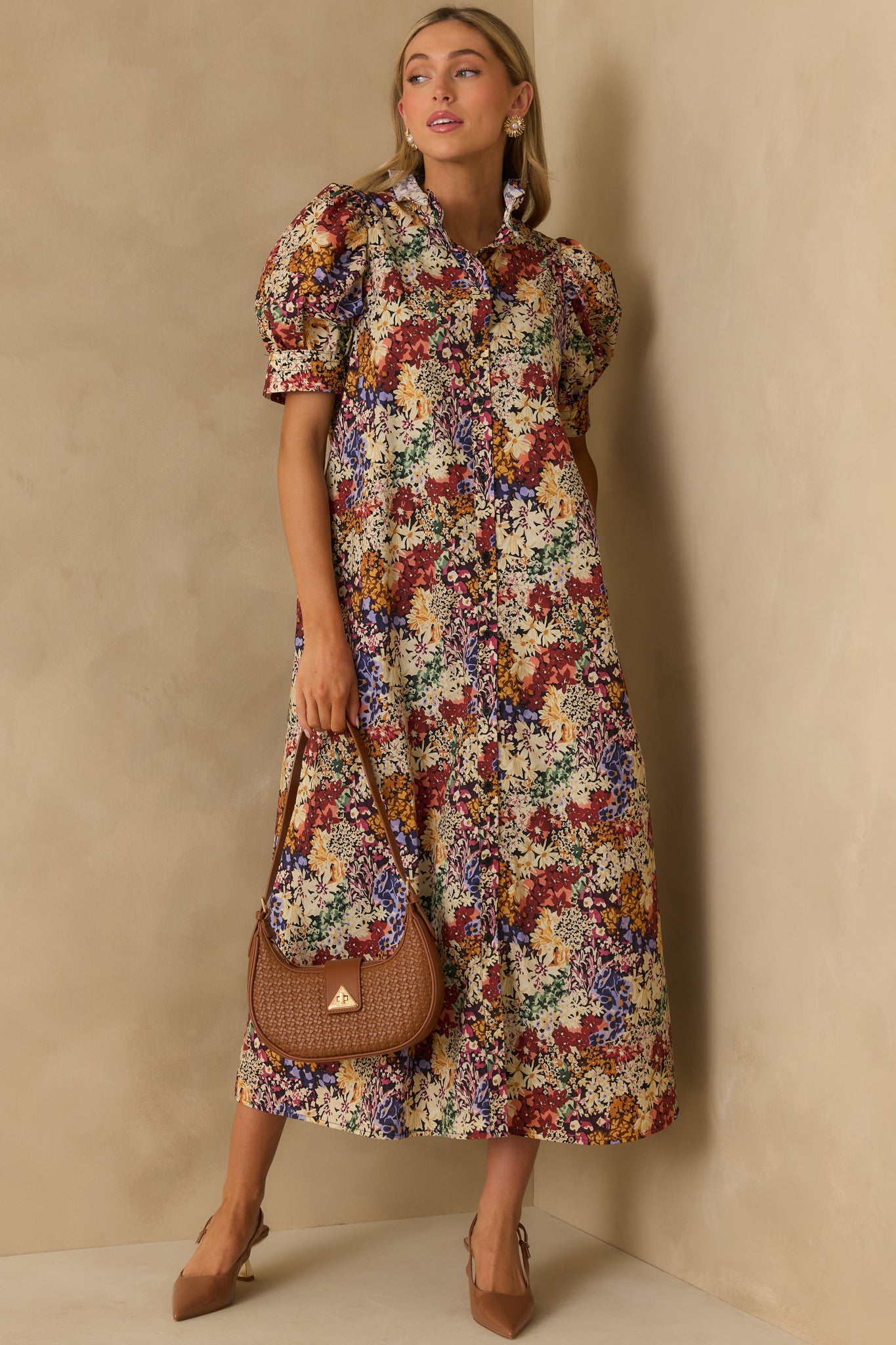 Ivory floral maxi dress with a ruffle trim neckline and short puff sleeves, finished with black top stitch accents.