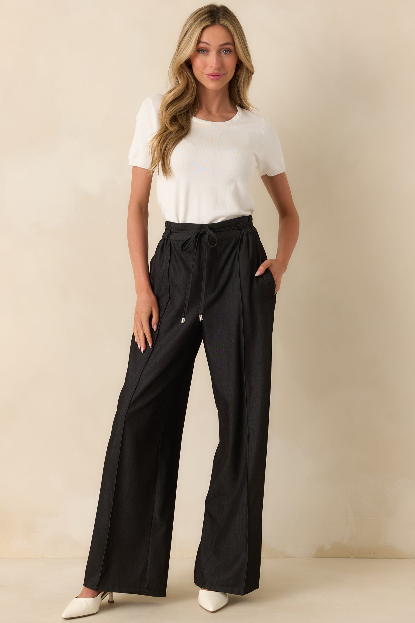 A full length shot emphasizing the casual fit and clean lines of the ivory sweater top.