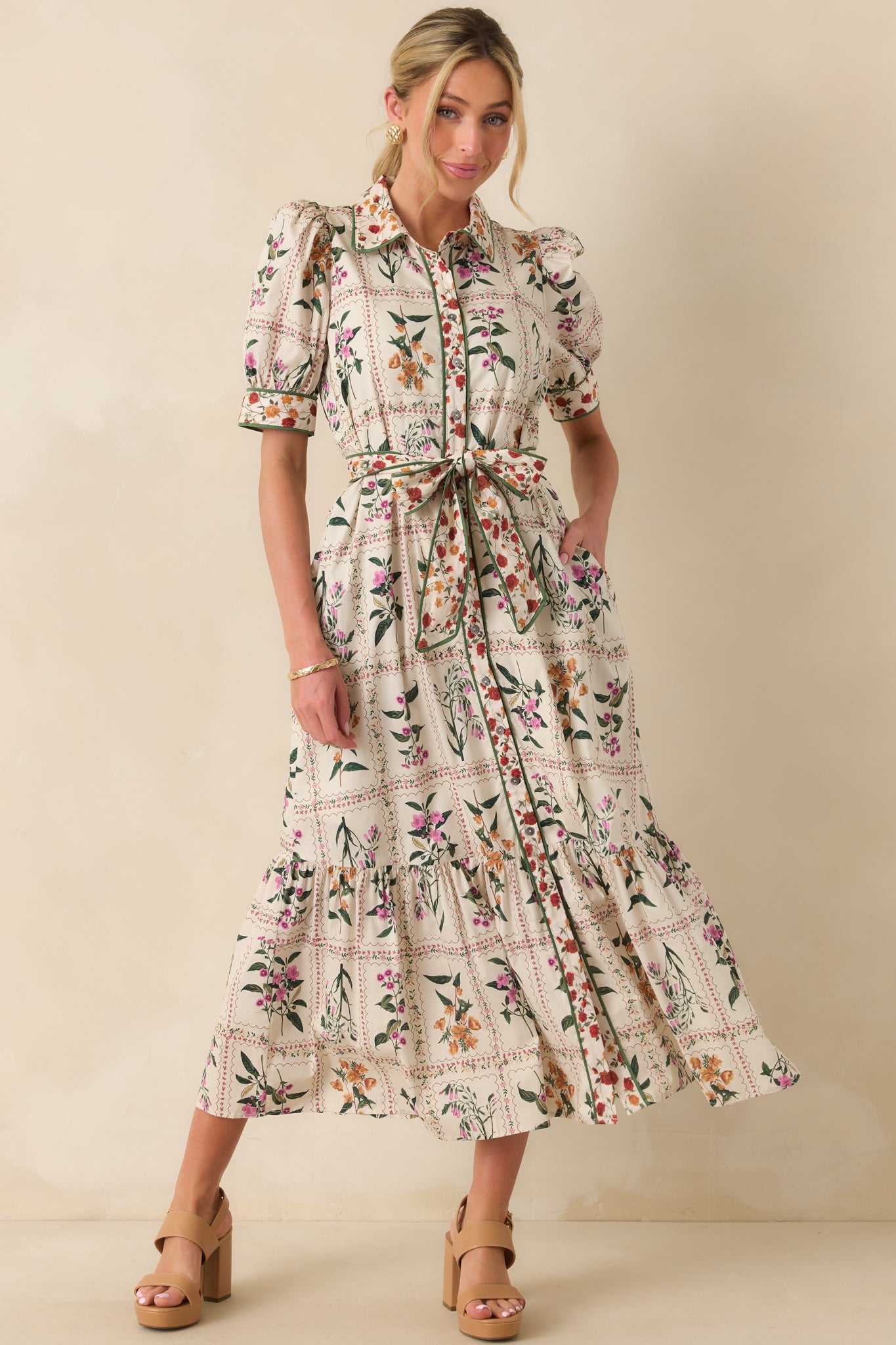 Full view of the ivory maxi dress highlighting the collared neckline, patchwork floral print, and puff sleeves.