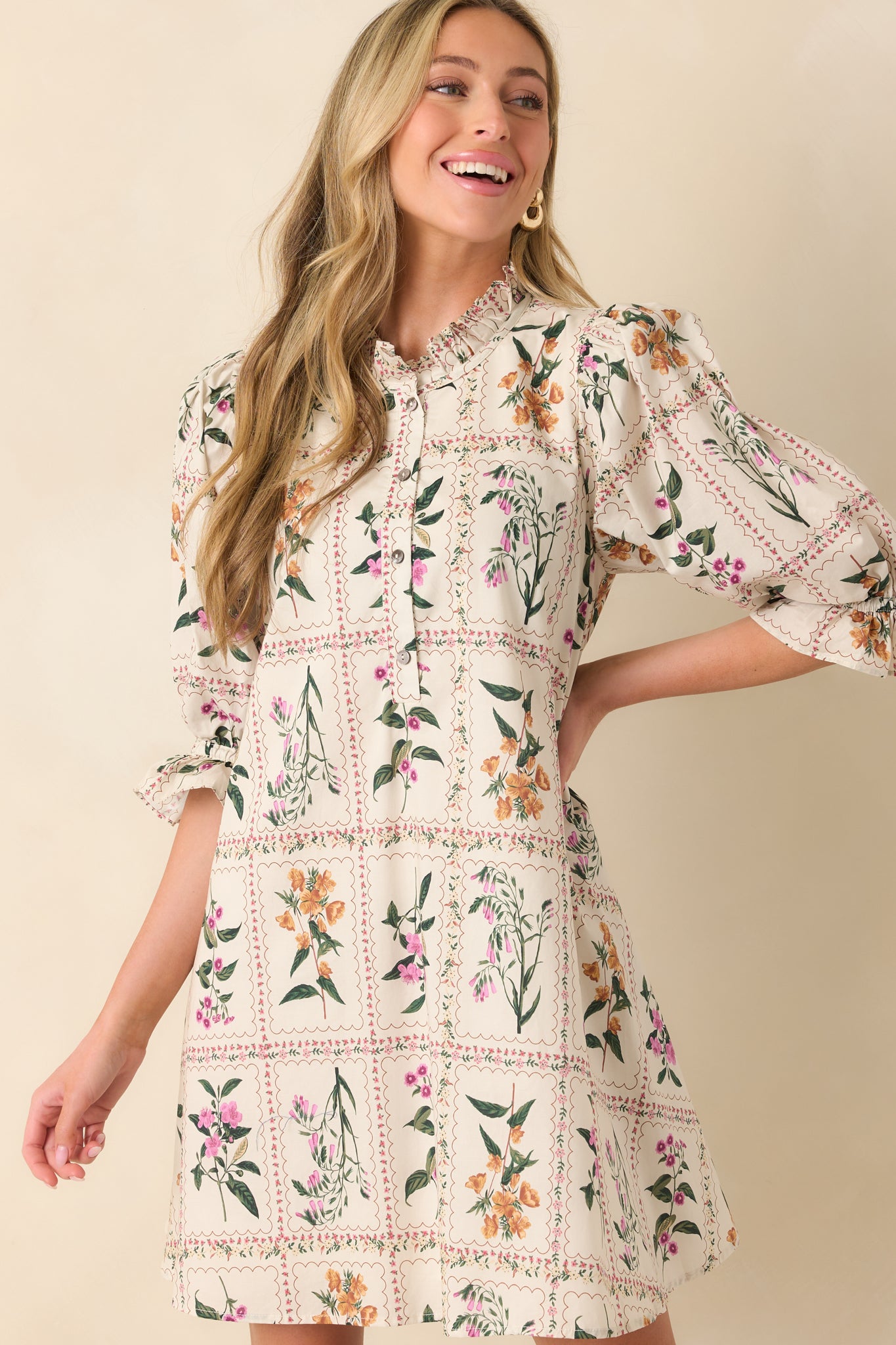 A cropped shot emphasizing the hemline and floral pattern near the bottom of the mini dress.