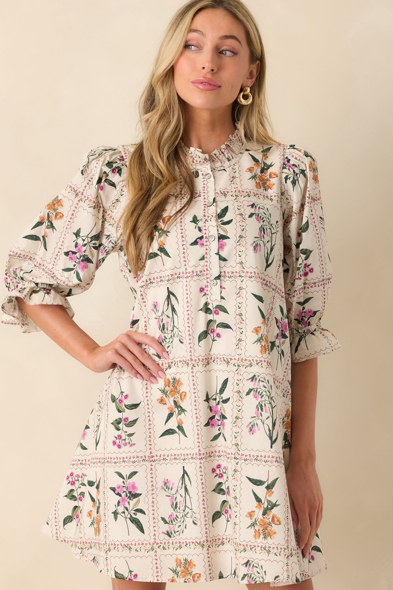 A cropped image focusing on the elastic cuff detail and floral patchwork on the sleeve.