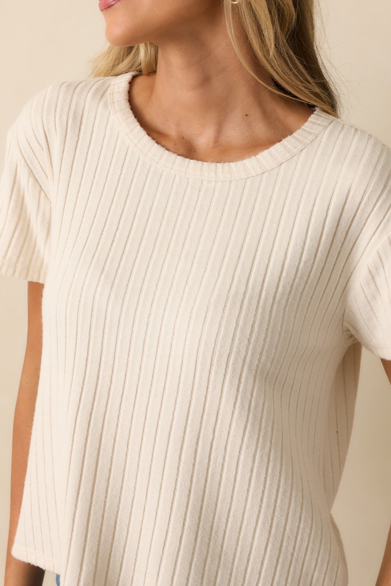 Detailed look at the ribbed texture and silky finish of the ivory tee.