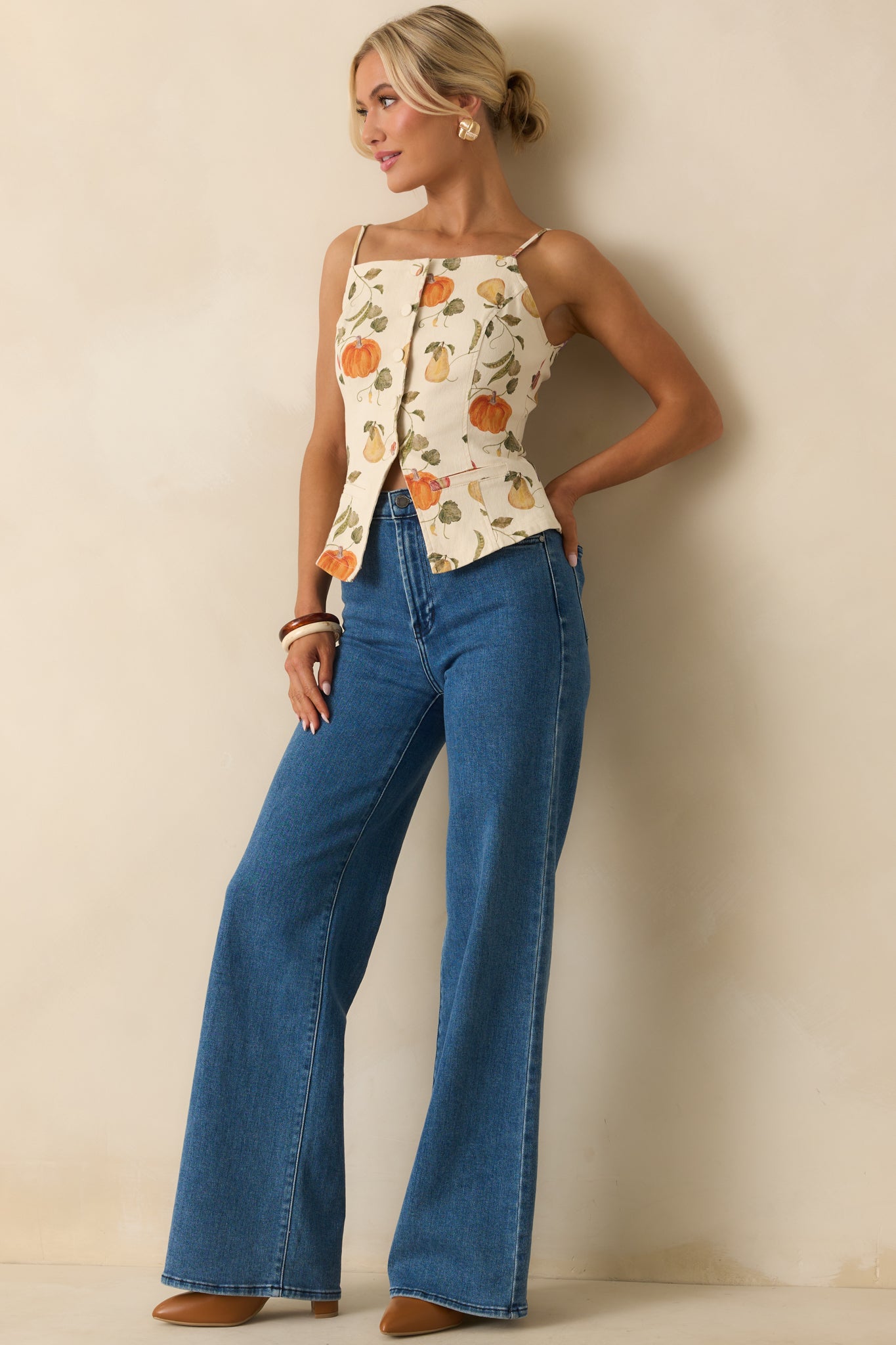 Ivory top with vegetable garden print, square neckline, and paneled waistcoat fit shown in full front view.