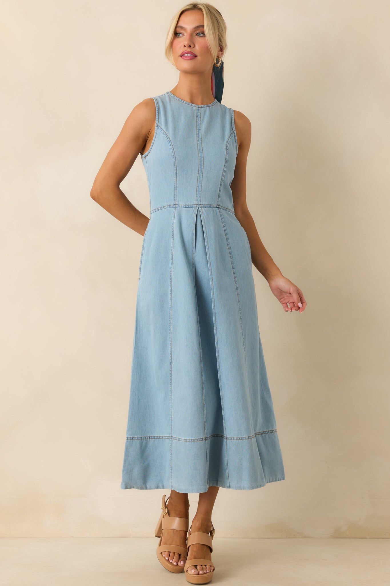 Chambray midi dress in light wash with front pleat accents, round neckline, and pocket detail.