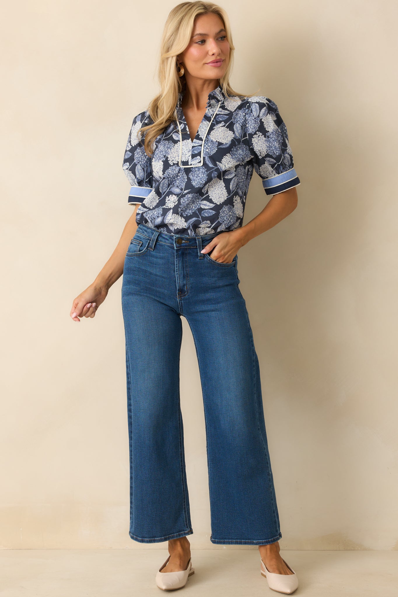 Lightweight top in a hydrangea flower pattern with ruffled neckline detail.