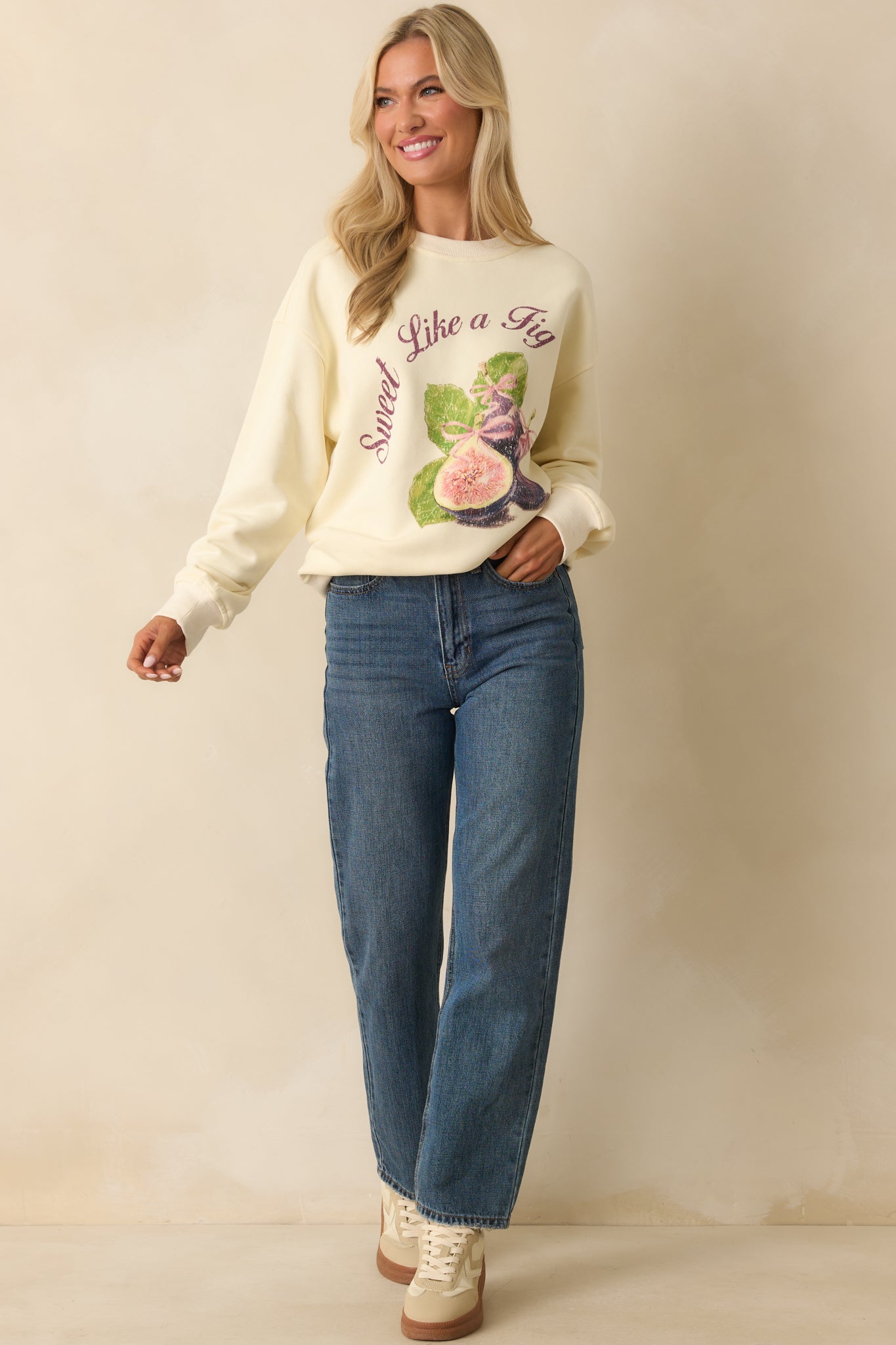 Long-sleeve ivory sweatshirt displayed front facing with ribbed hems and bold retro fig artwork.