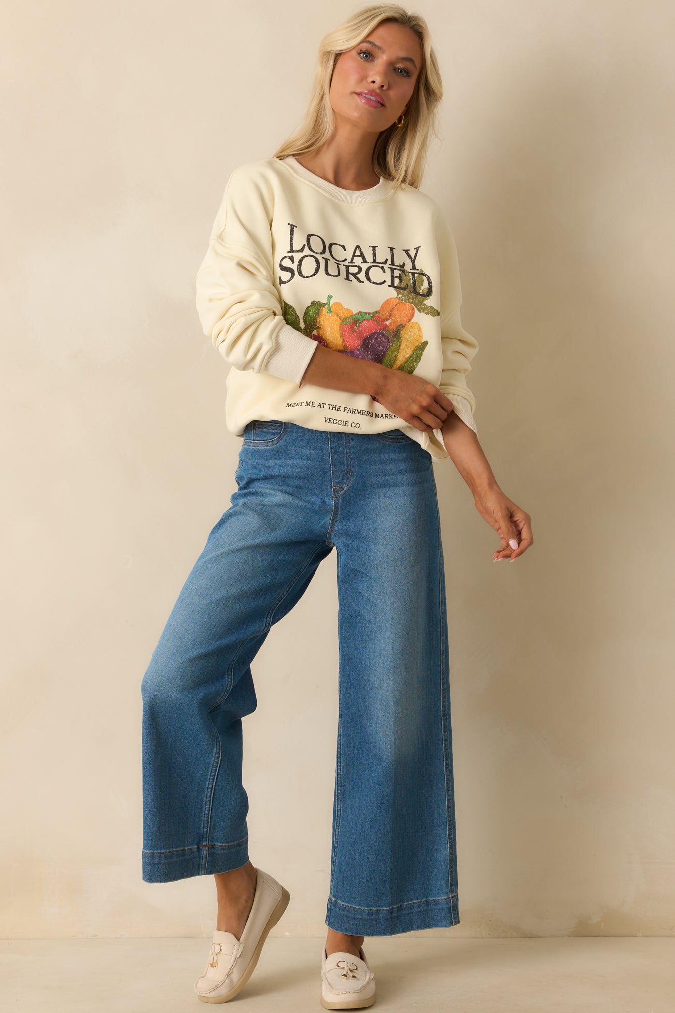 Long-sleeve ivory sweatshirt displayed front view with drop shoulders and bold veggie design.