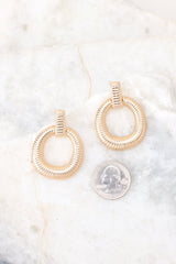 Size comparison of these gold earrings with rectangular ribbed stud connected to ribbed hoop.