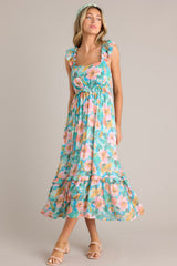 Side view of this Floral square-neck dress with elastic sleeves, smocked back, elastic waistband, and flowy skirt