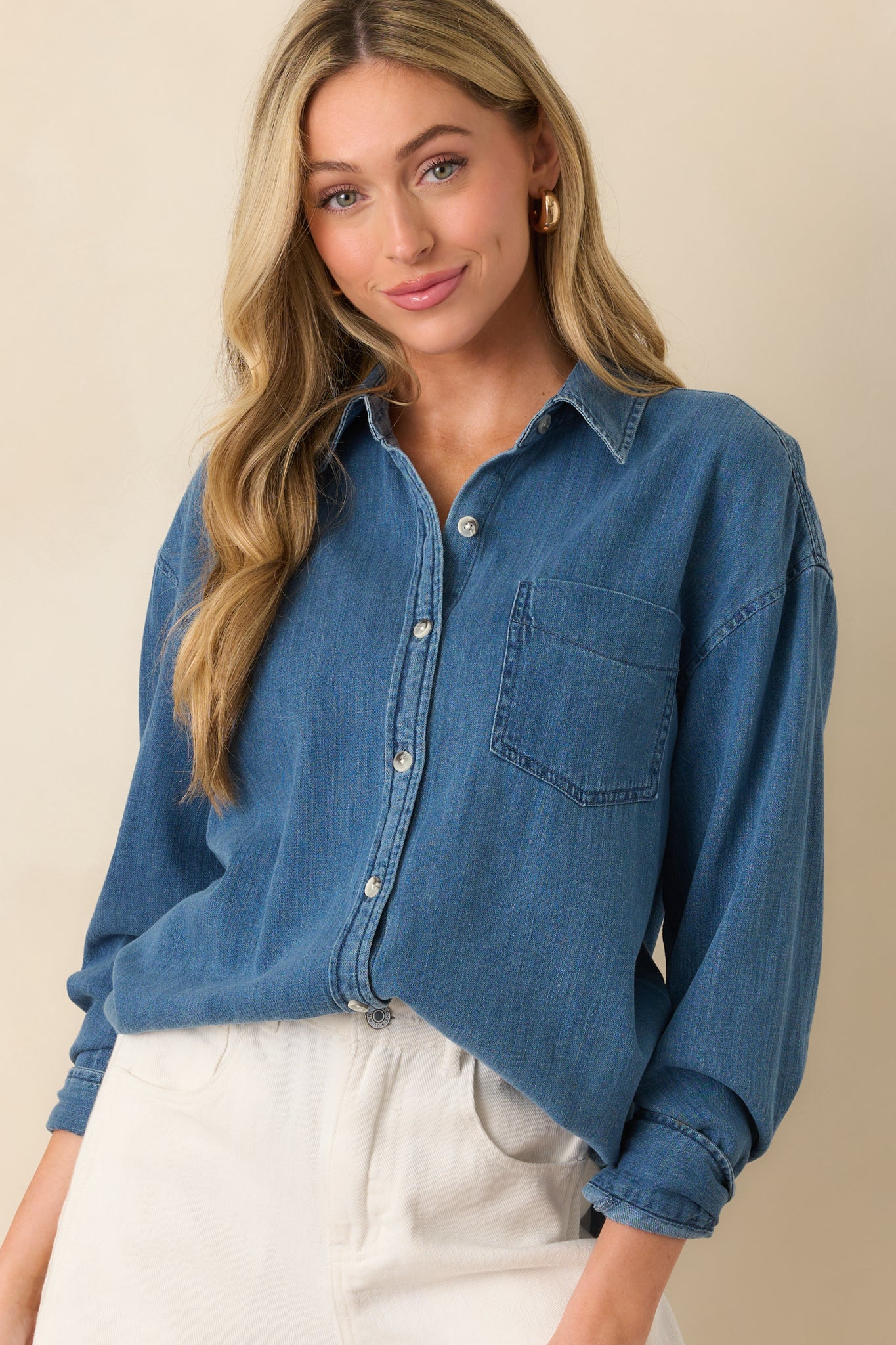 Cropped shot of the hemline, capturing the scoop shape and drape of the fabric.