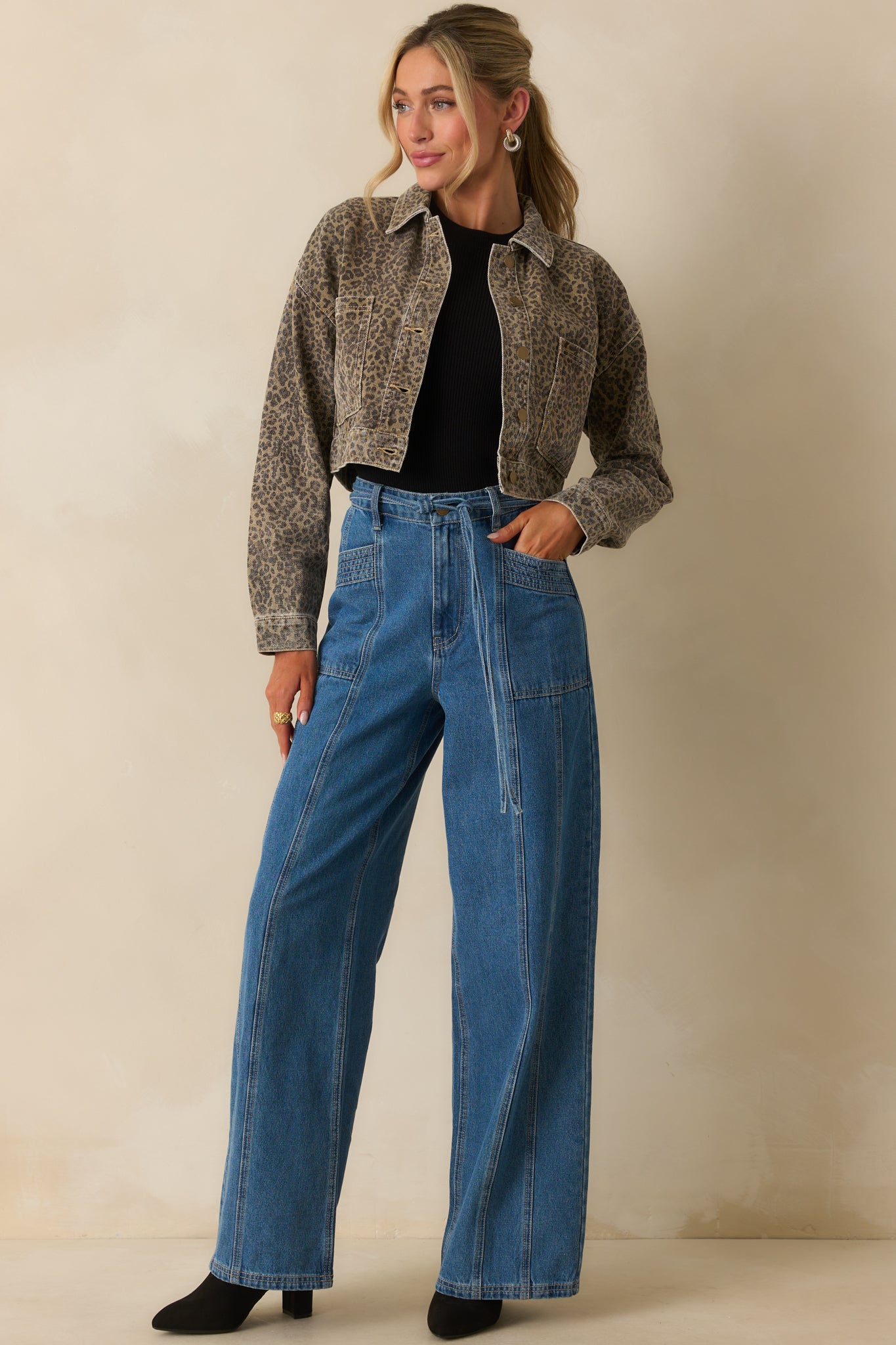 Medium wash wide-leg jeans with a high rise waist and paneled design.