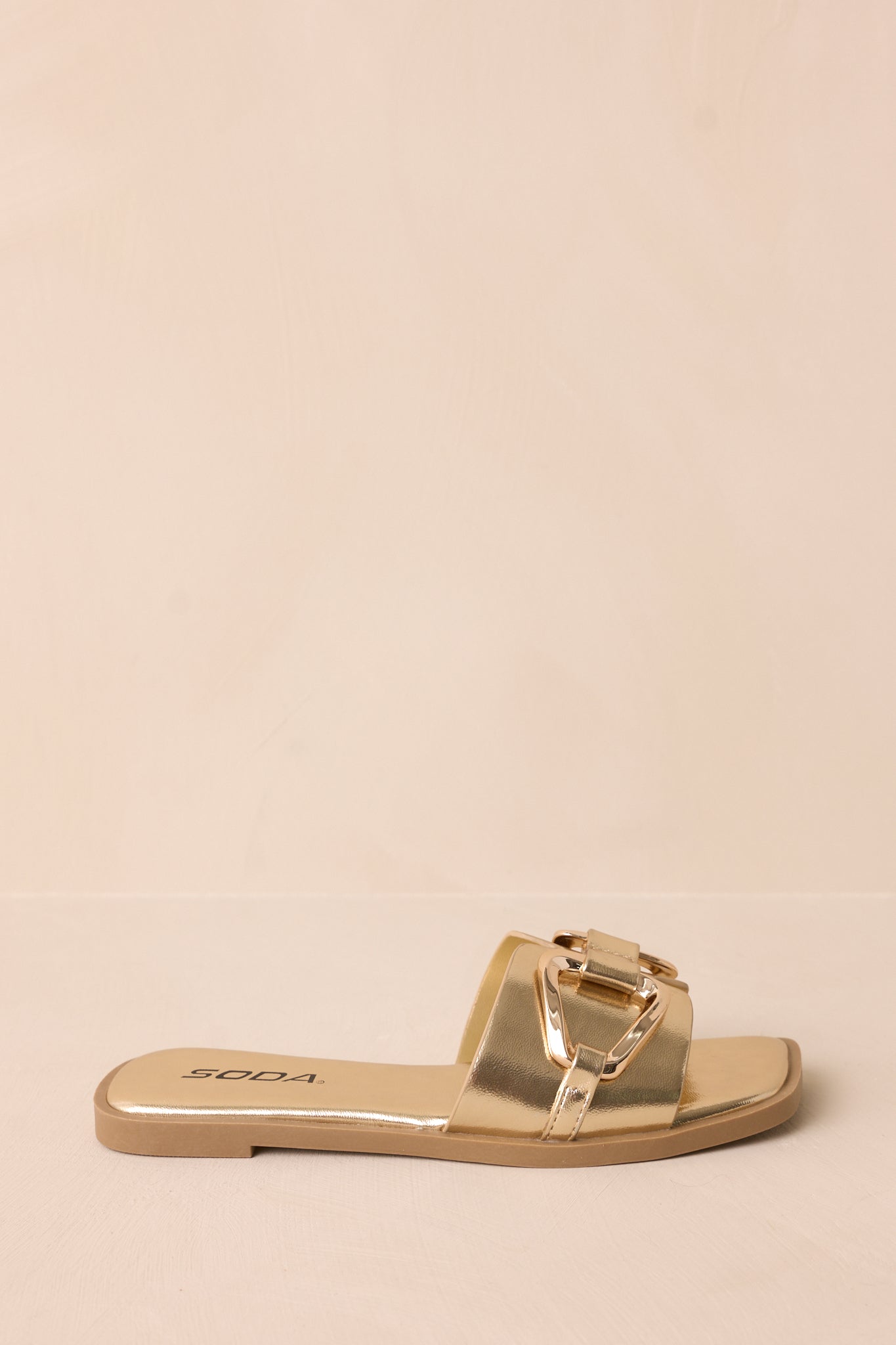 Profile shot of the sandal displaying the shape, notched band, and sleek design of the slip-on style.