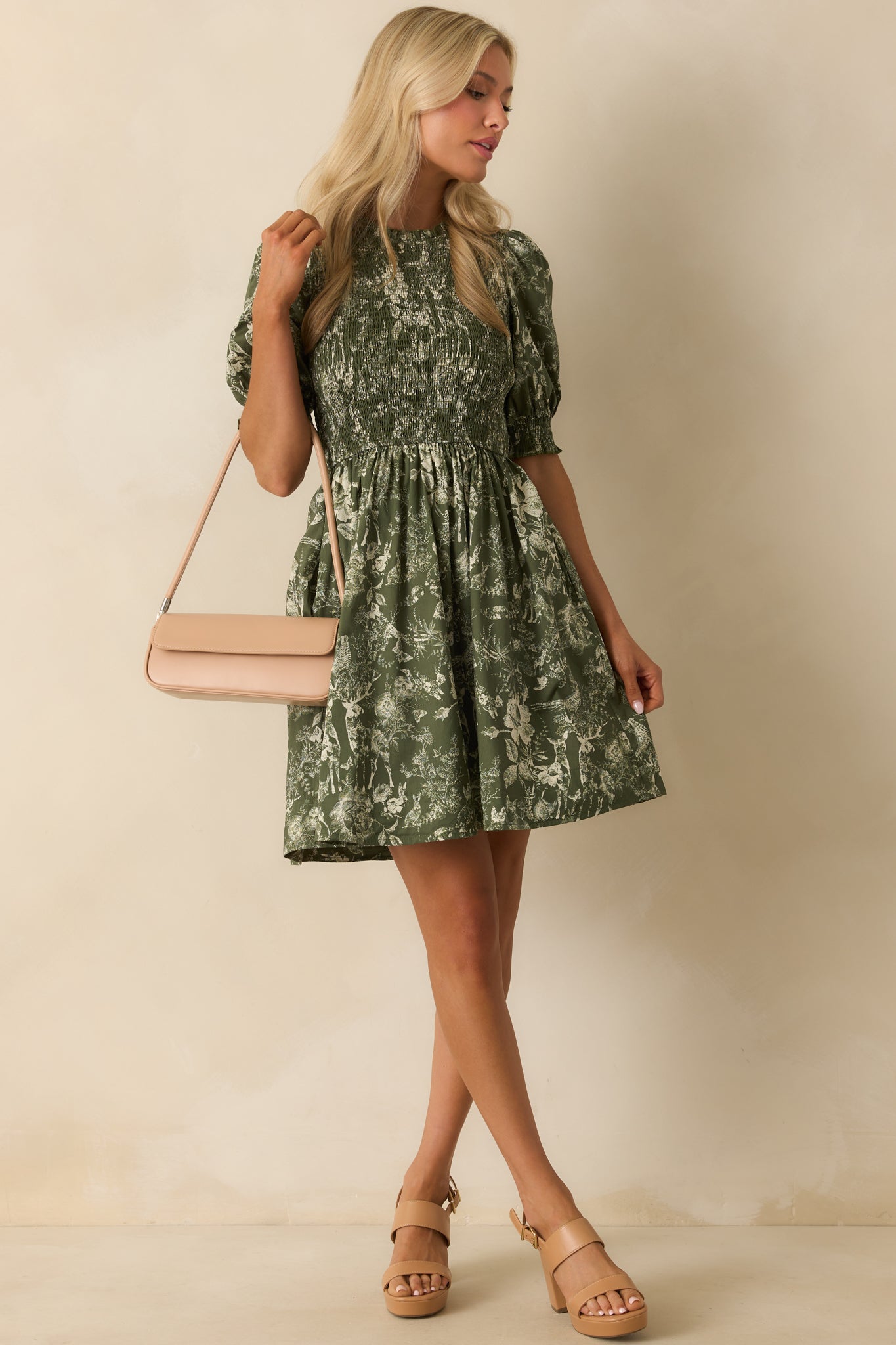 Mini dress featuring a ruffle trim round neckline, smocked cuffs, and functional side pockets.