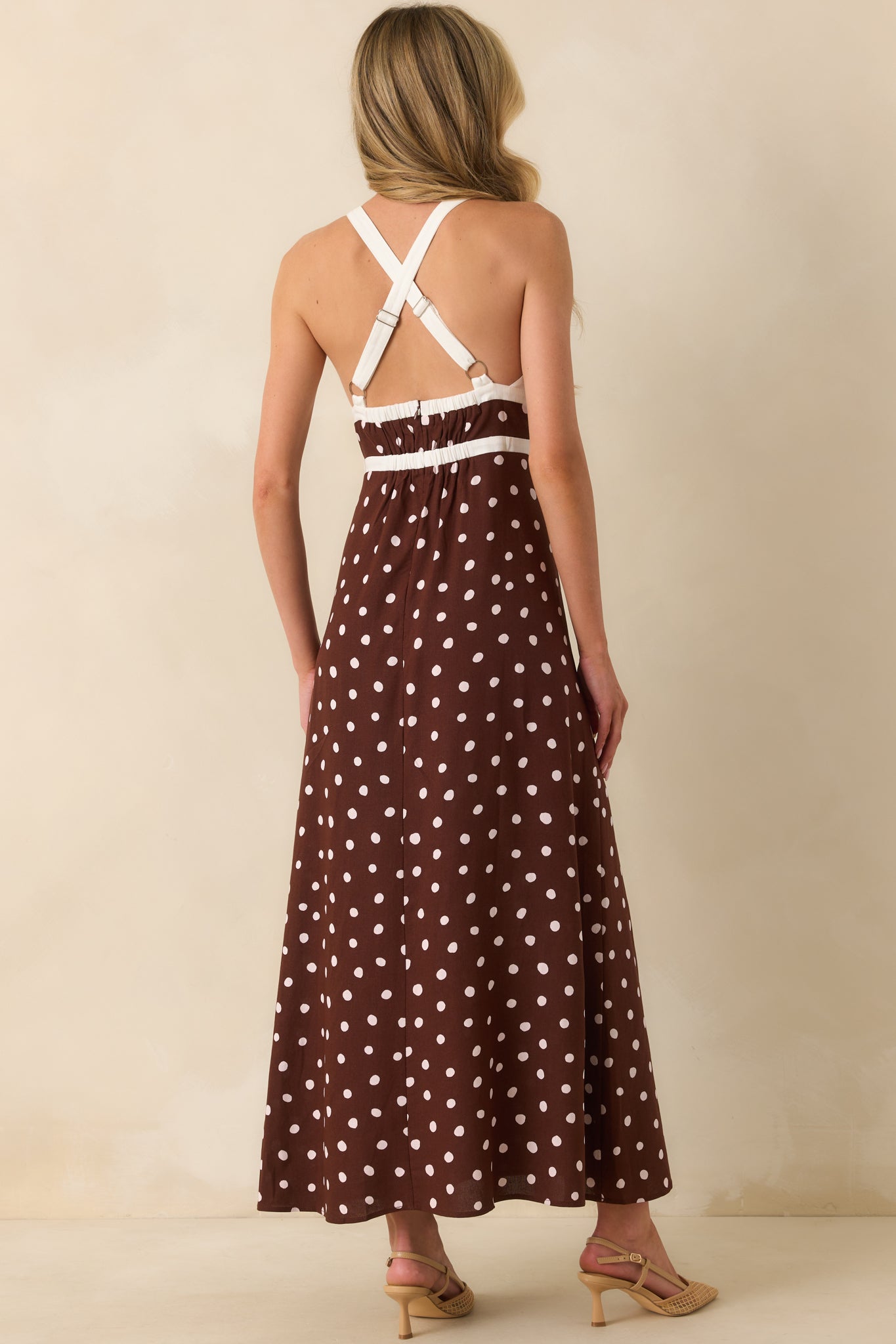 Rear view of the maxi dress highlighting adjustable wide cross back straps, elastic back inserts, and hidden zipper closure.