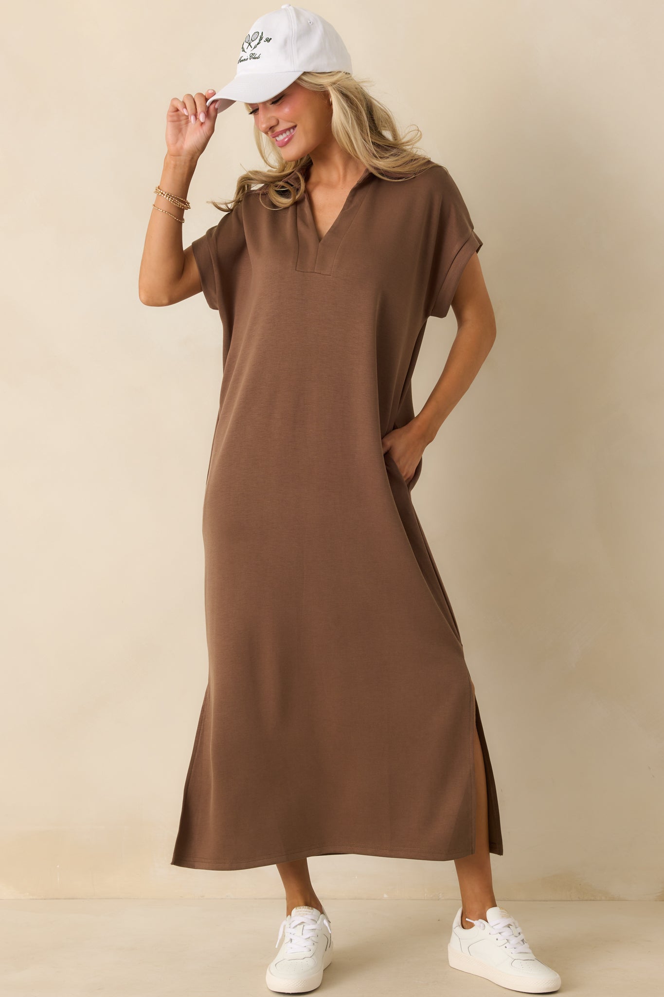 Mocha brown midi dress with short sleeves, a collared notch v-neckline, side vent leg slits, and a relaxed fit with functional pockets.