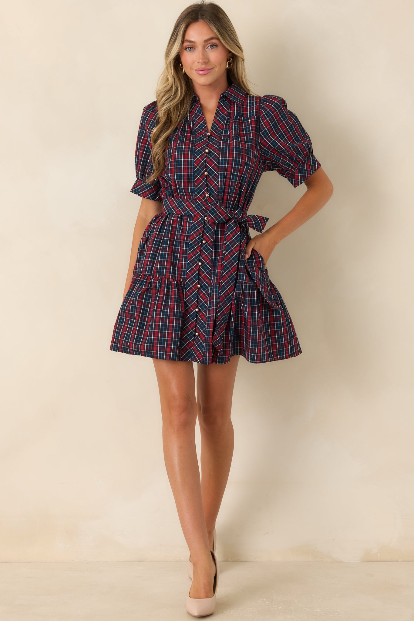 Navy and red plaid cotton mini dress featuring a collared neckline, puff sleeves, and tie waist.