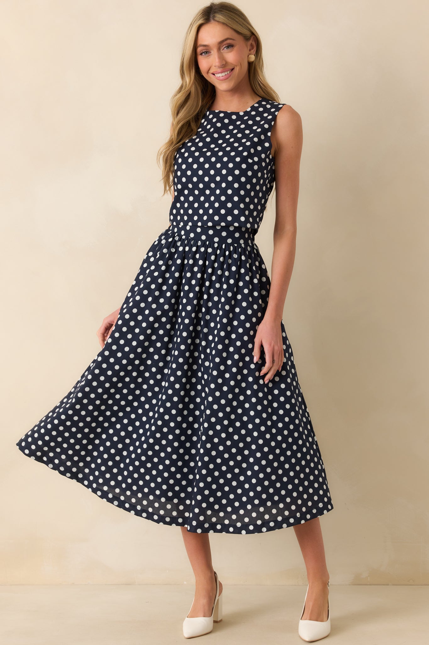 Polka dot midi skirt in navy and white, featuring a flattering shape and casual, versatile style.