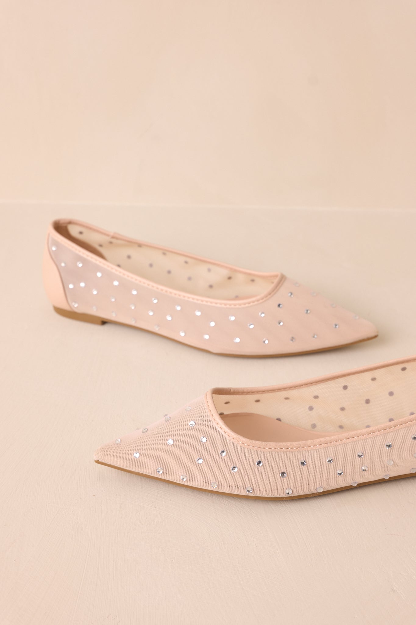A different angled side perspective showcasing the pointed toe and shimmering embellishments.