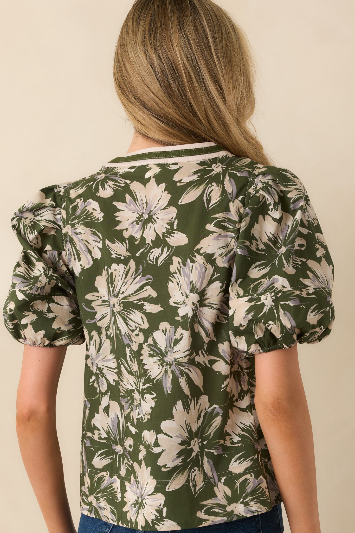Rear view of the top highlighting the puff sleeves, elastic cuffs, and overall relaxed fit from the back.