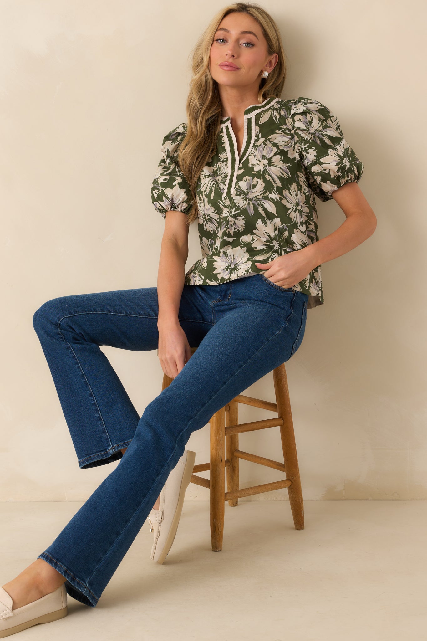 Front-facing olive green top highlighting contrast trim detailing along the neckline and sleeves.