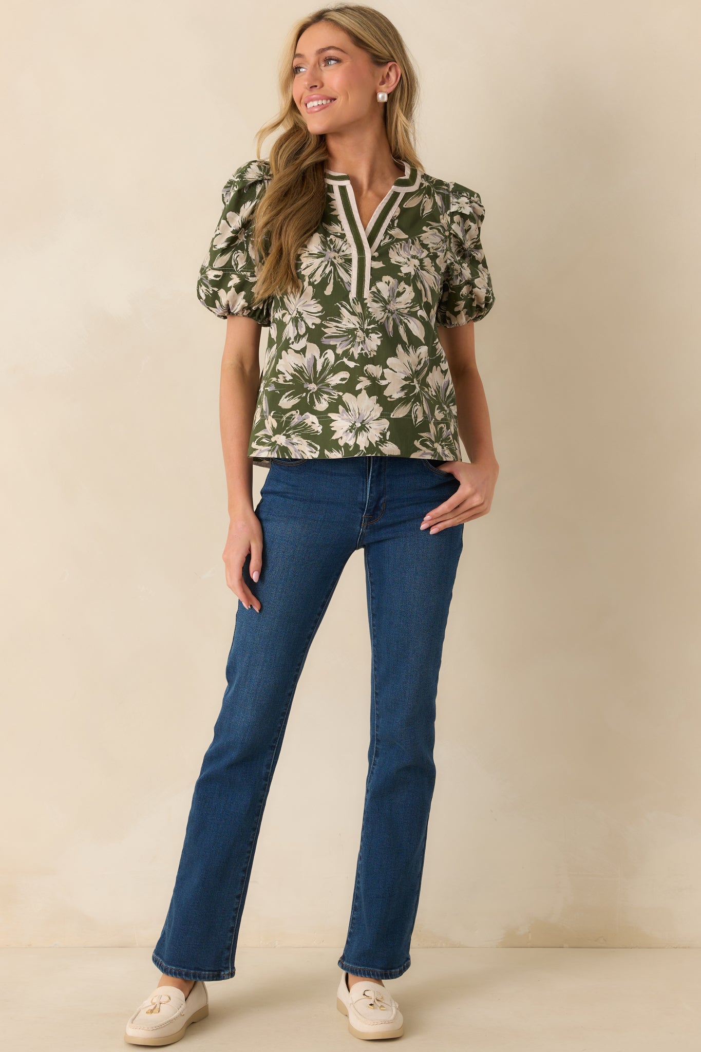 Front shot of the top showing floral print, elasticated short sleeves, and a notch v-neckline.