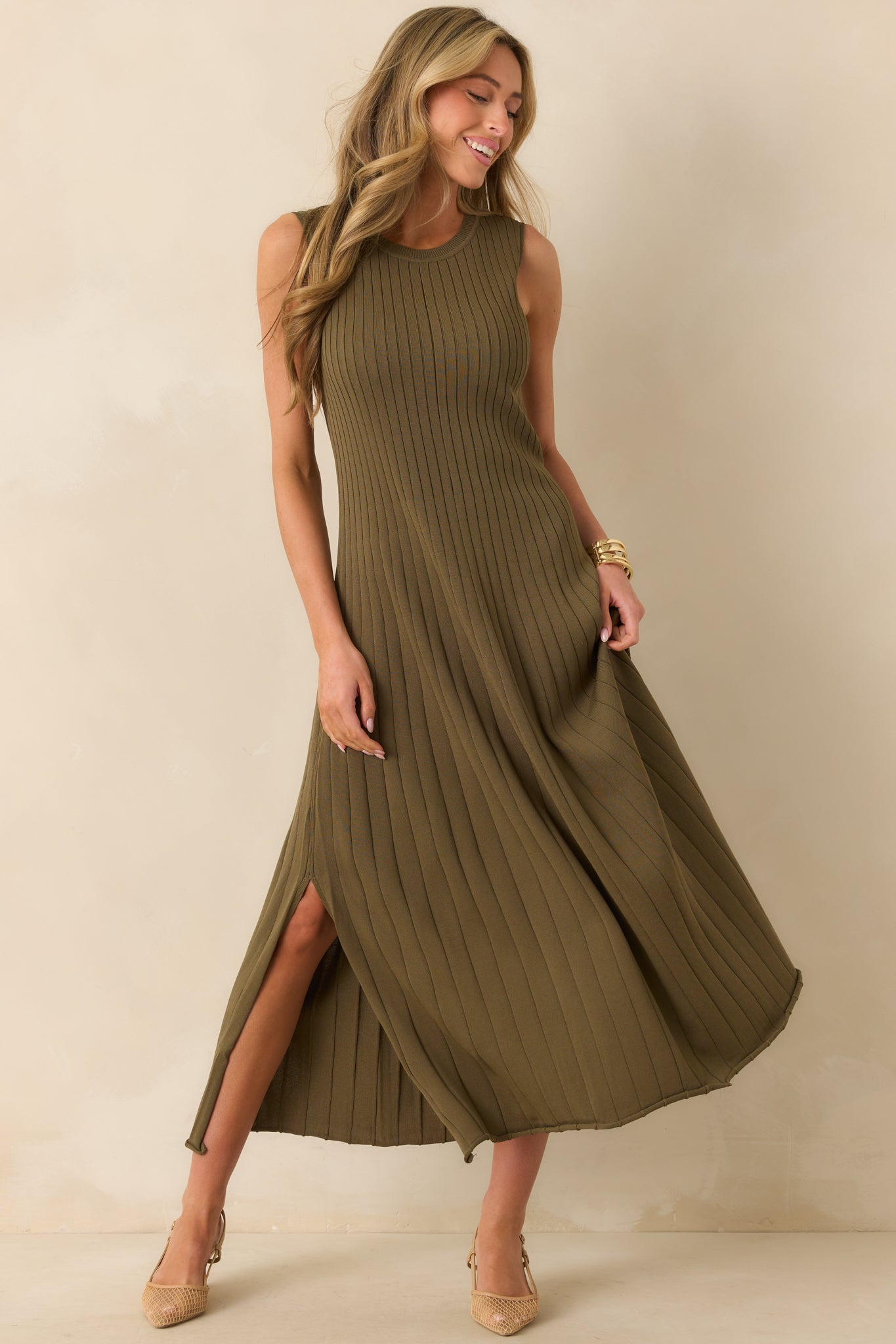 Olive green ribbed knit midi dress featuring round neckline and vent slits at the hem.