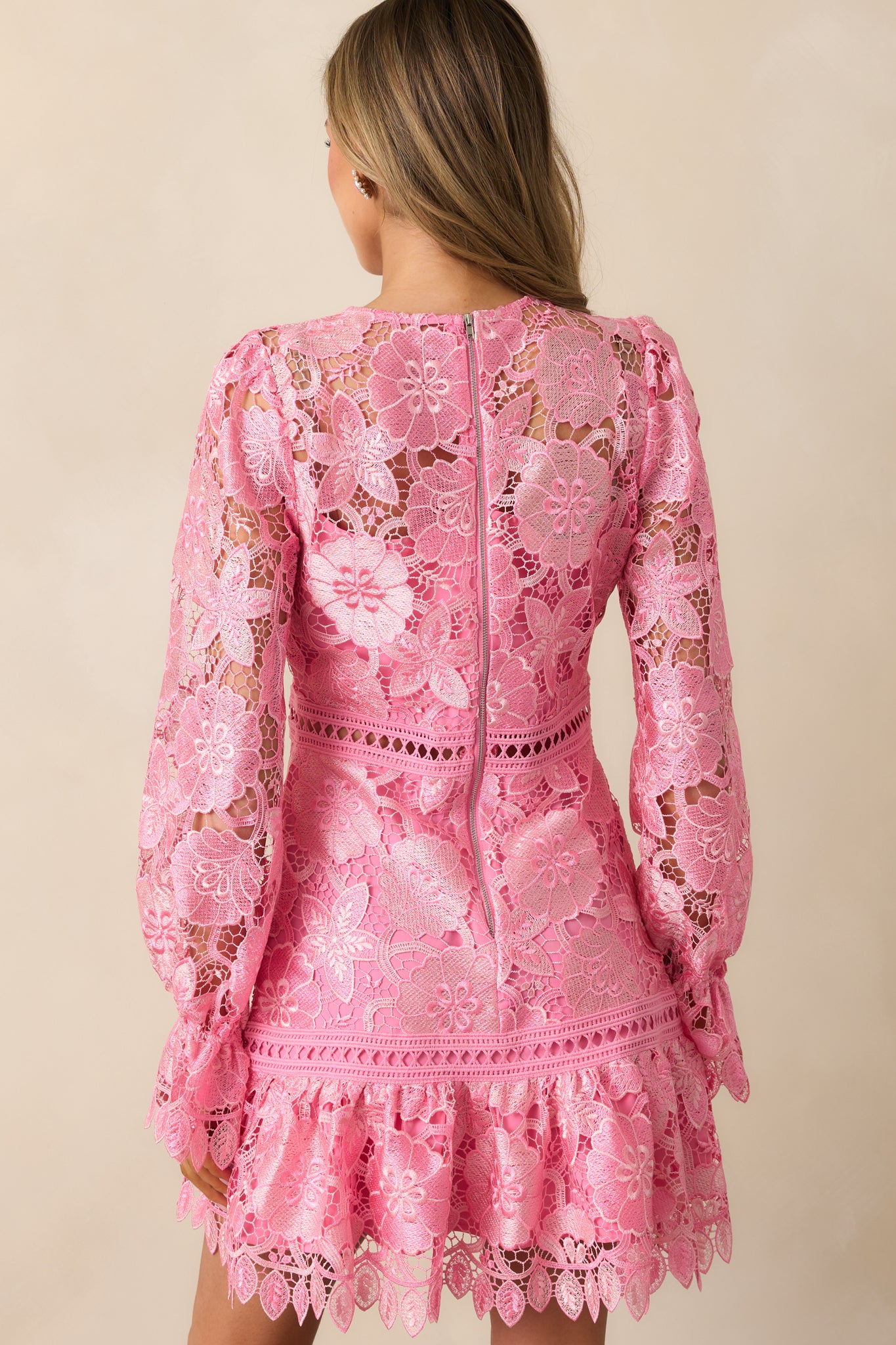 The back of the dress, showing the zipper closure and the continued floral embroidery on the fabric.