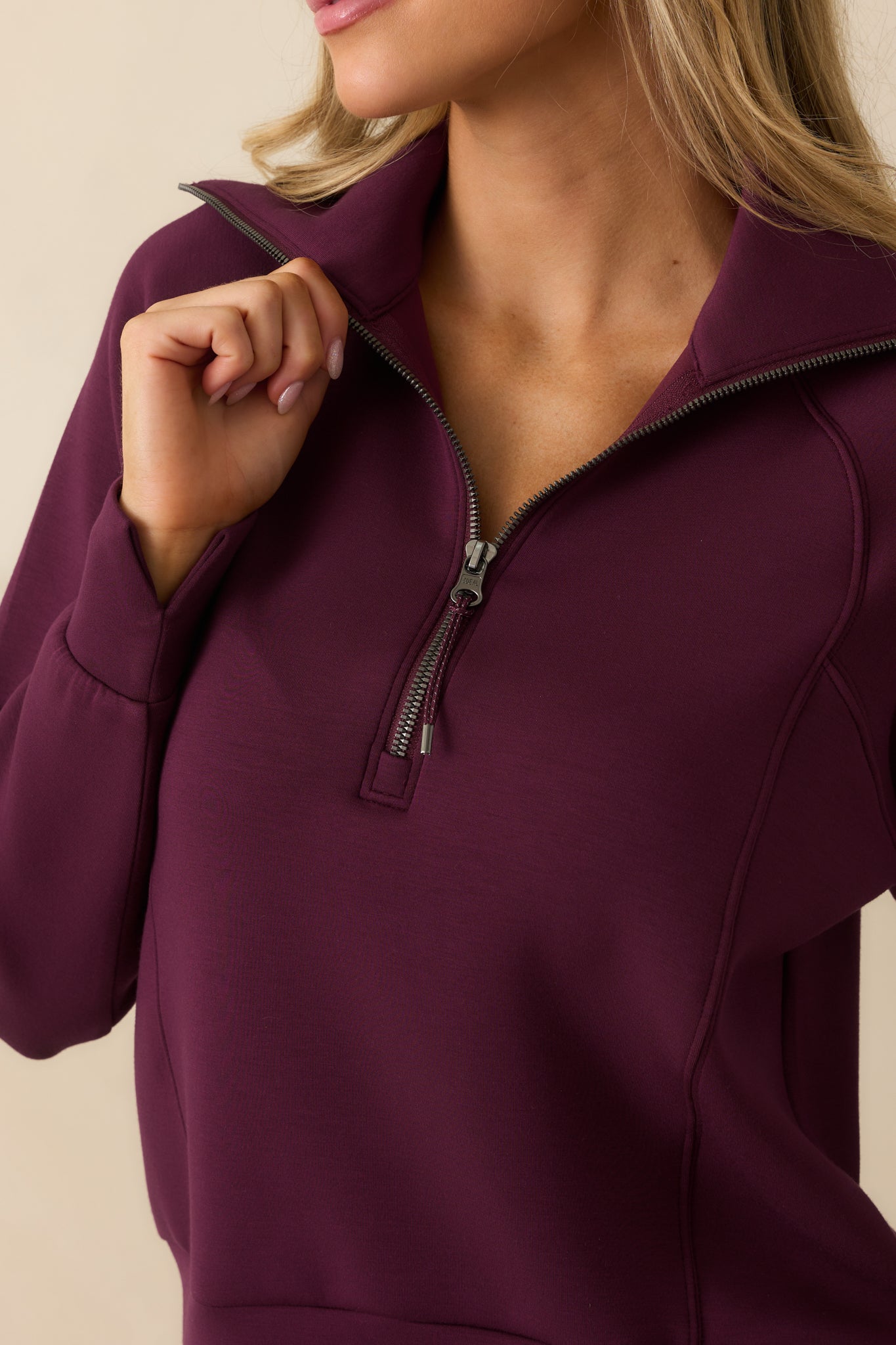 Zoomed-in shot of the pullover’s fine knit structure and silky texture in plum berry.