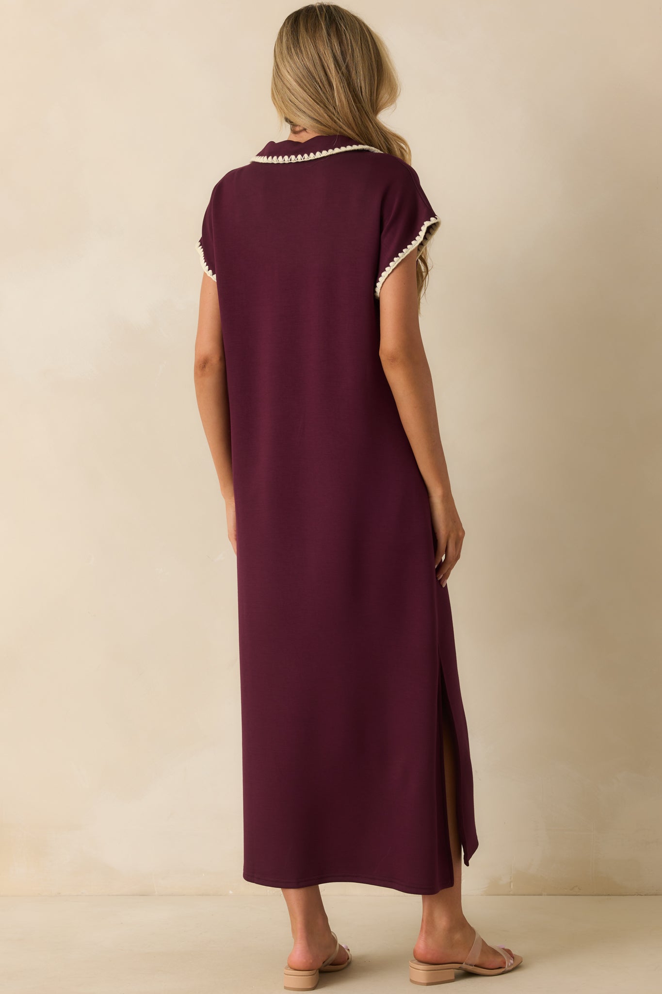 Rear view of the plum purple maxi dress with relaxed fit and side slit detail.