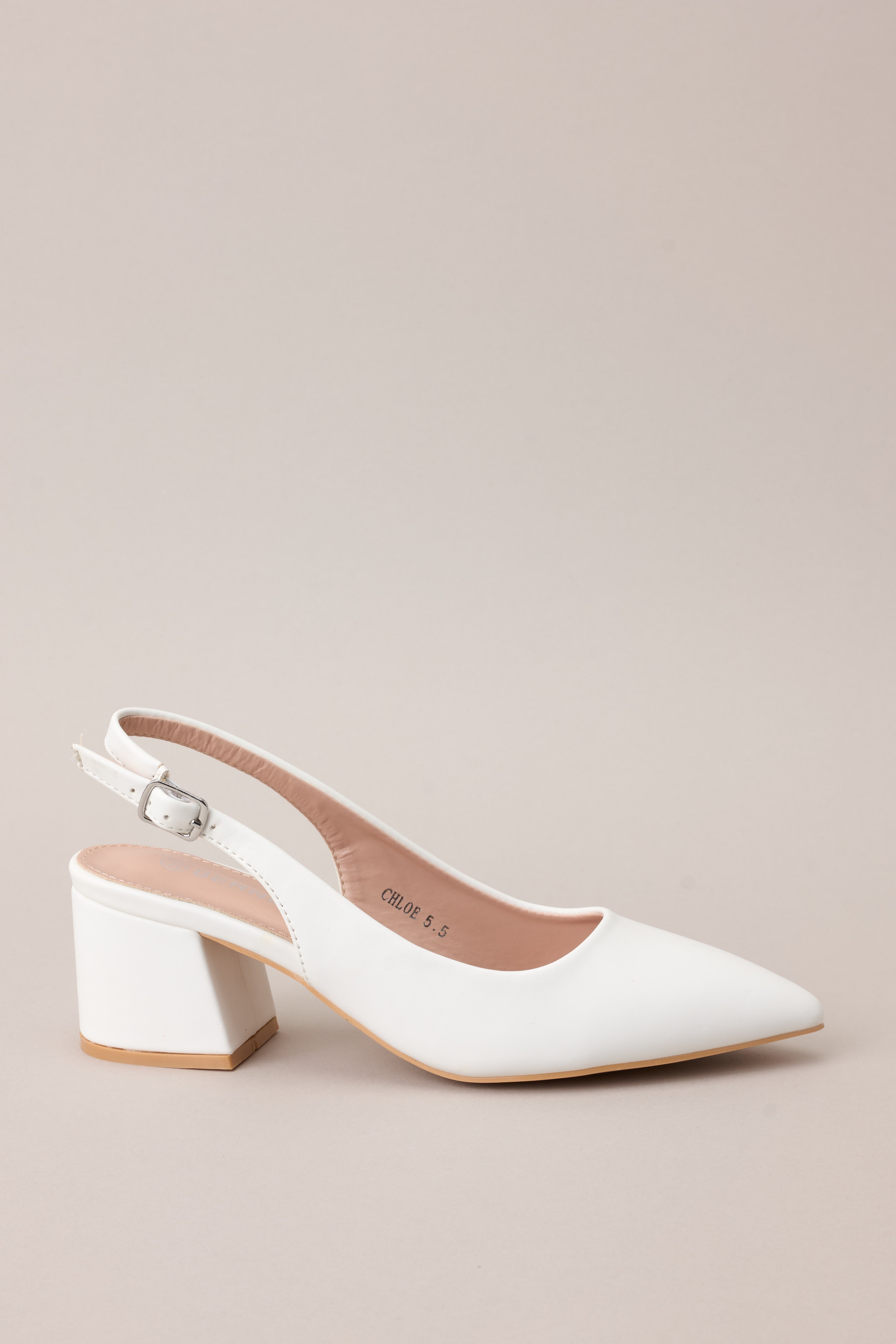 A profile shot showcasing the entire heel, pointed toe, and sleek faux leather material.