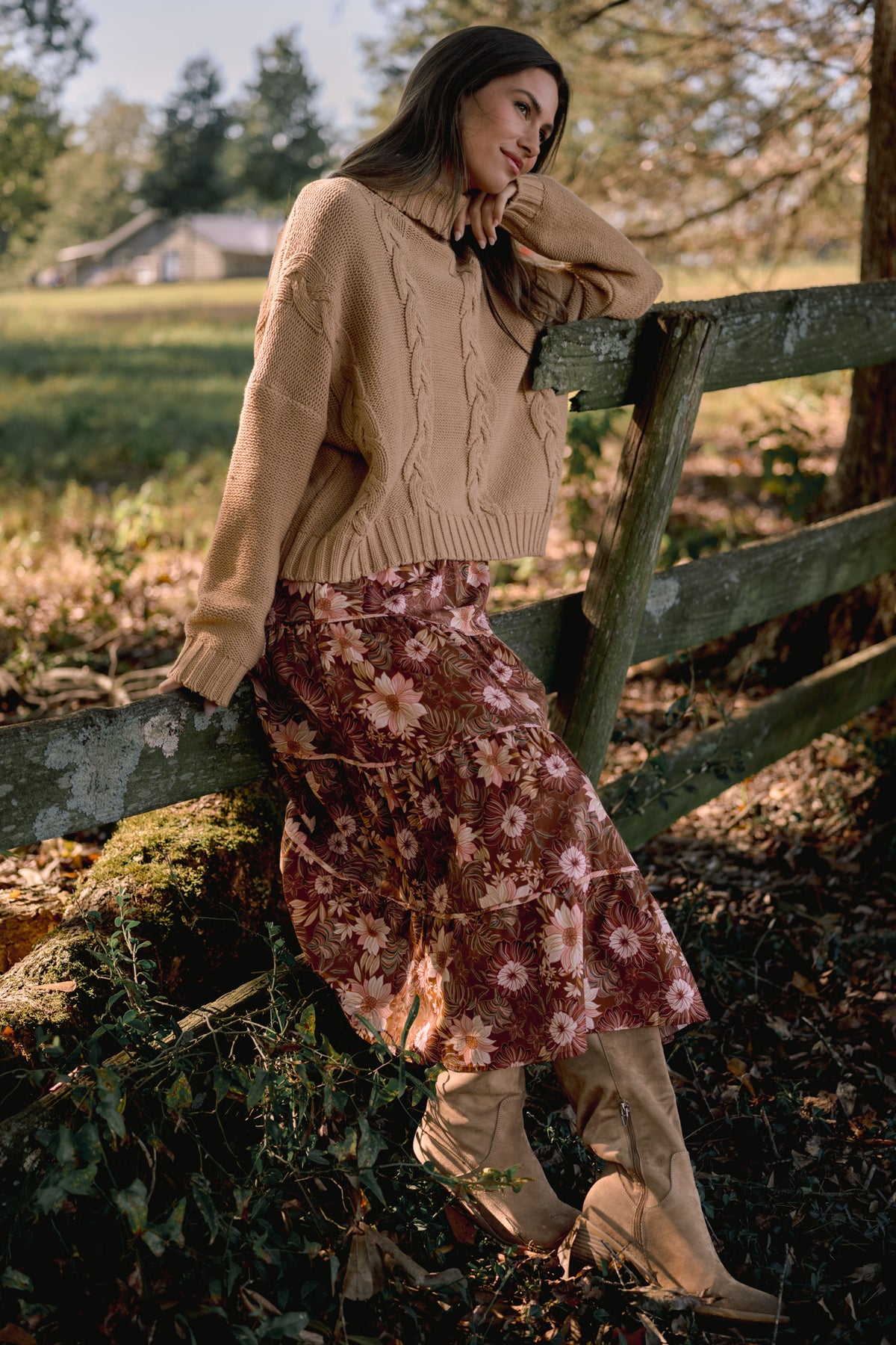 Model wearing a brown and pink floral tiered midi skirt with a gathered waist and flowing silhouette.