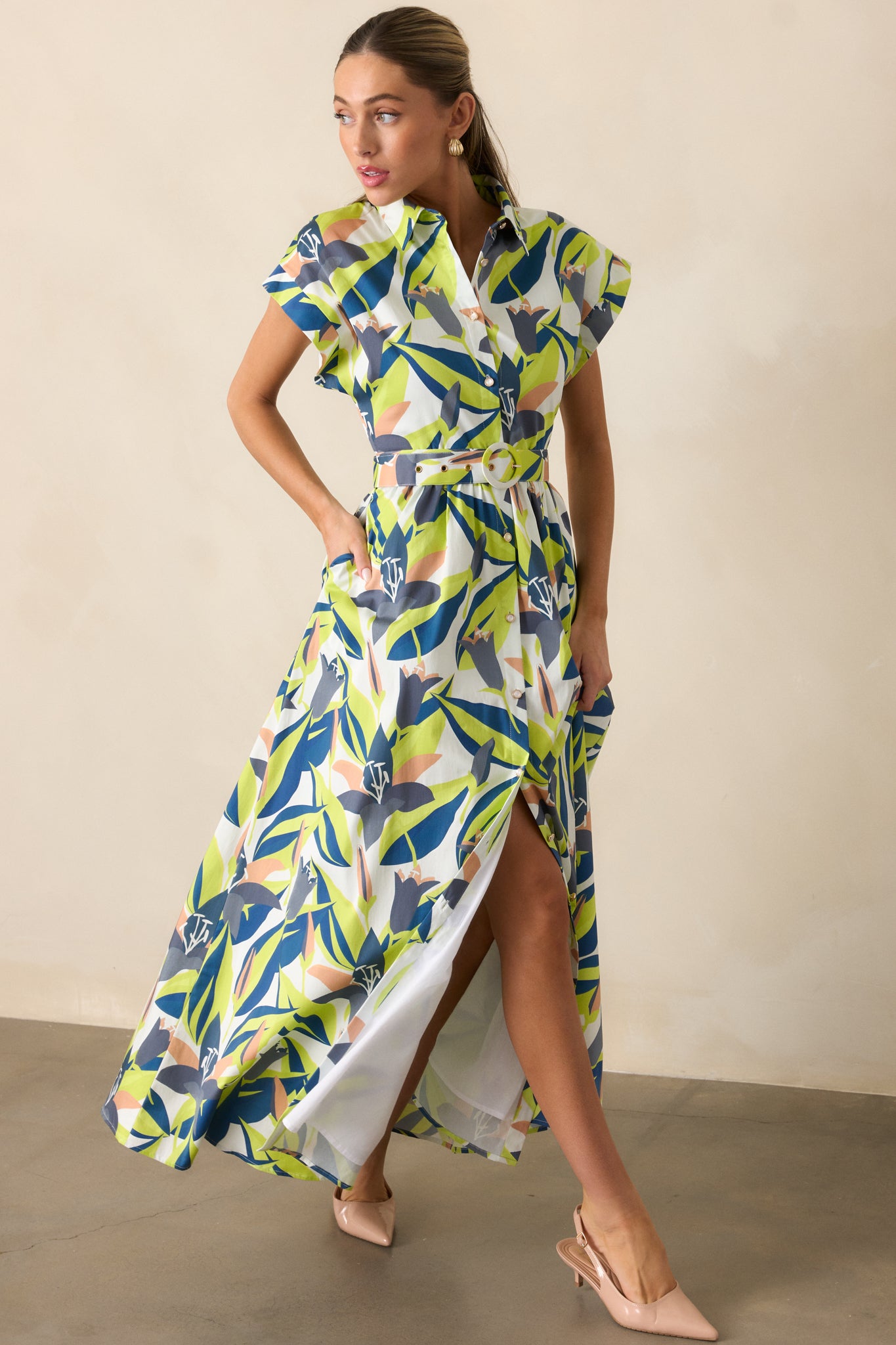 Front view of maxi dress featuring optional adjustable belt, full white lining, and functional pockets.
