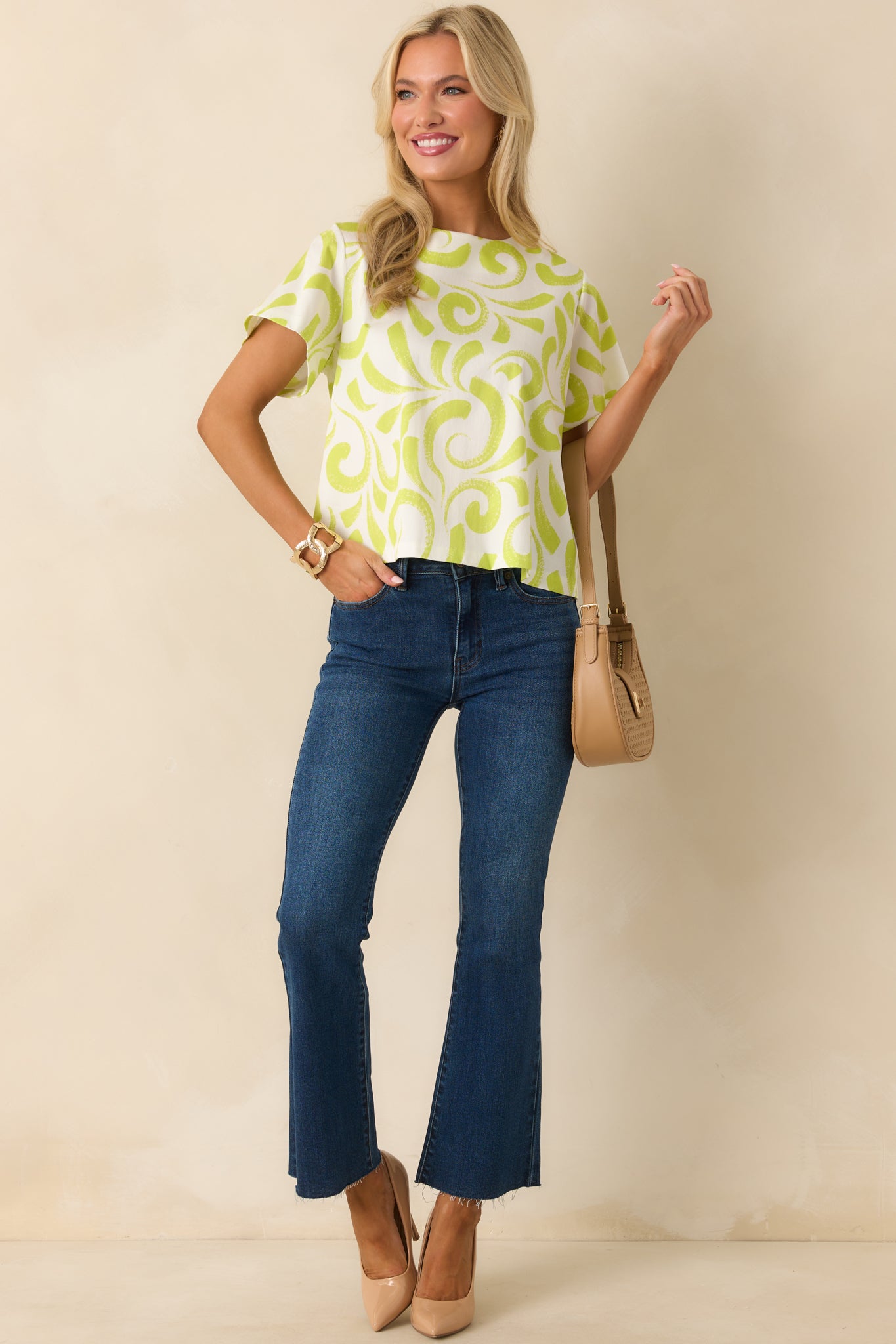 Front view of lime green and white brush stroke print top featuring short sleeves and lightweight cotton fabric.