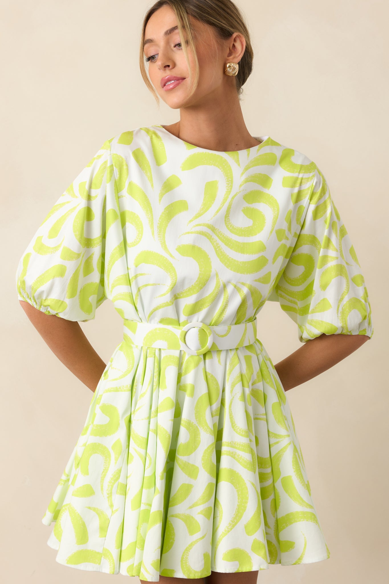 Close crop showing the brush stroke pattern and silhouette of the fit-and-flare skirt.