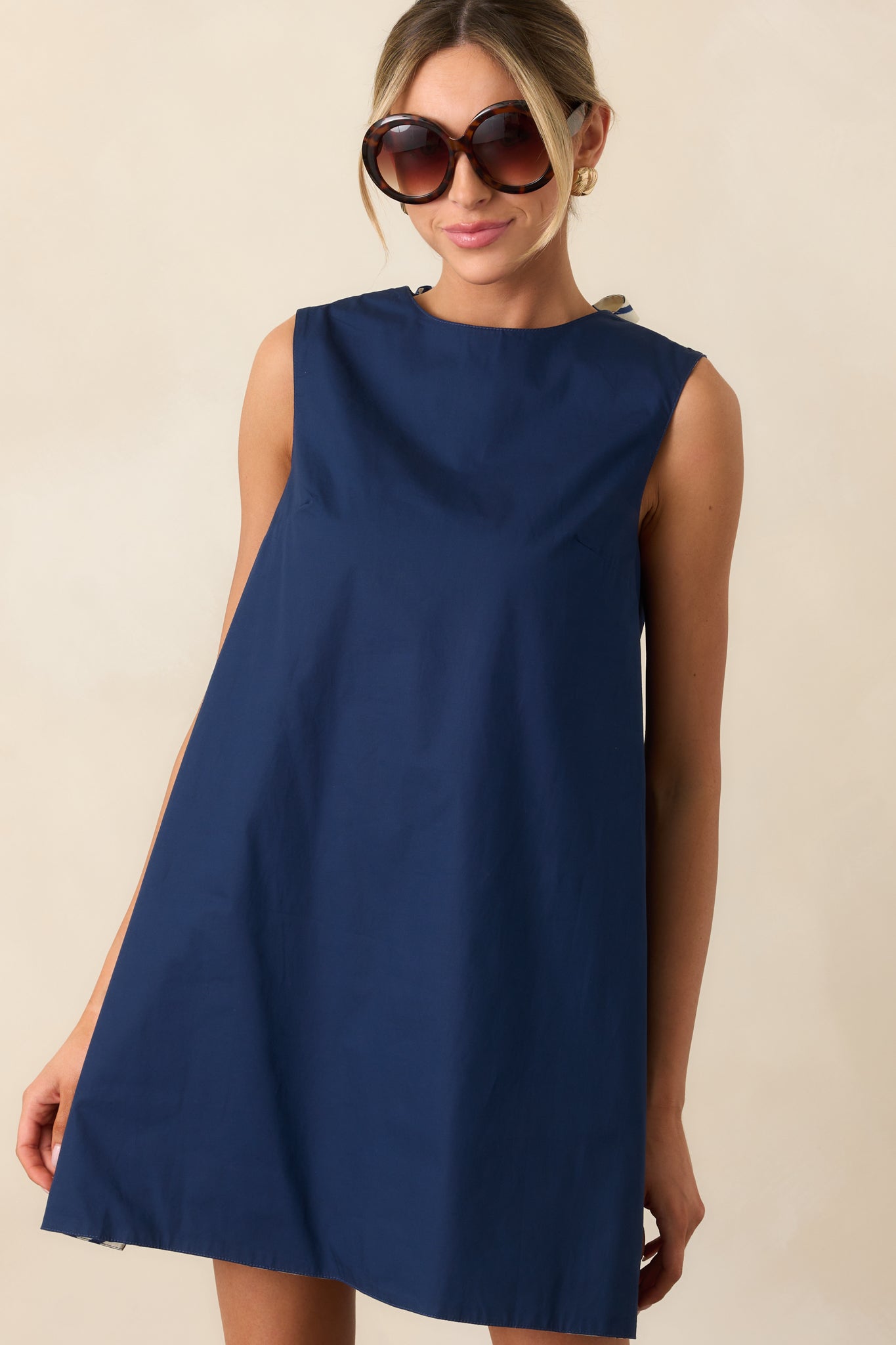 Close cropped shot of mini dress highlighting reversible fabric design and shift silhouette.