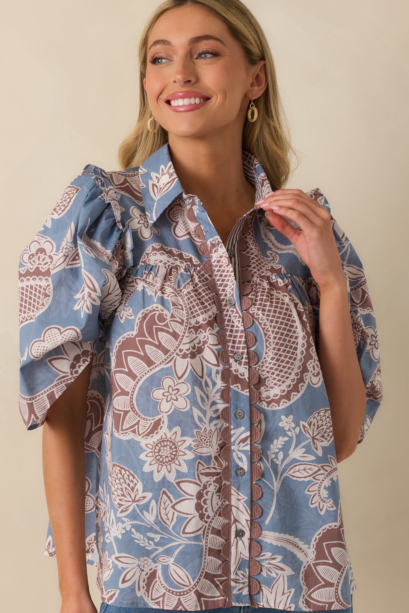 Puff sleeve design with gathered shoulders shown in the ash blue and mauve blouse.