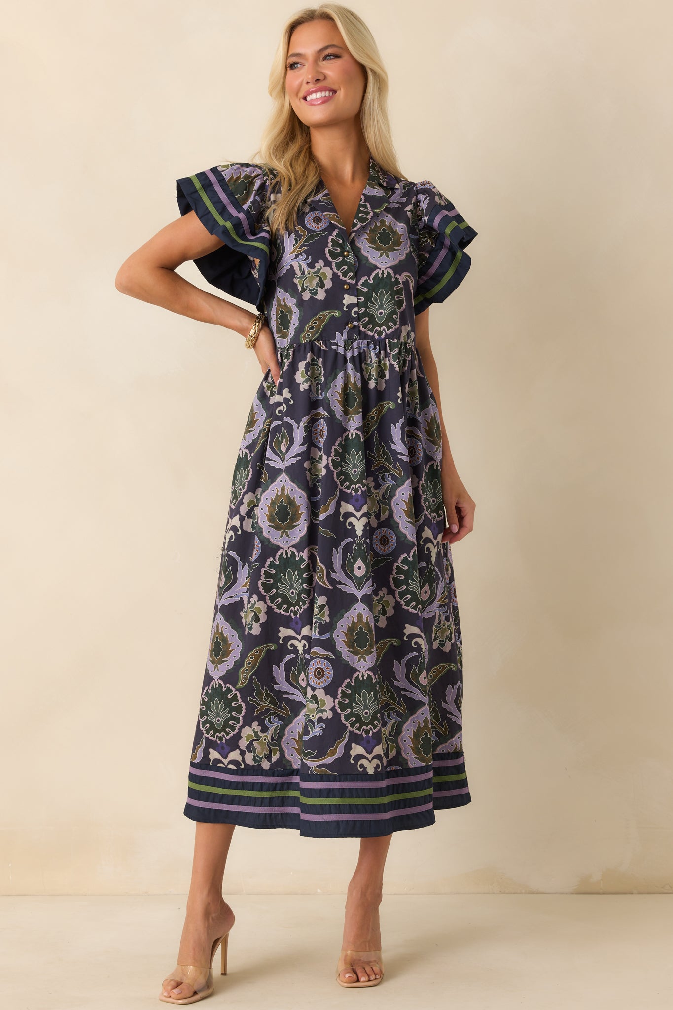 Straight-on full body image emphasizing the green and purple trim details and the relaxed midi-length skirt.