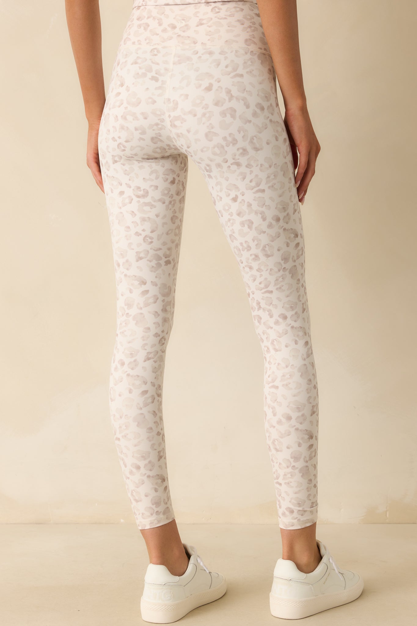 Rear view of the ivory leopard print leggings with a high-rise fit and streamlined seams.