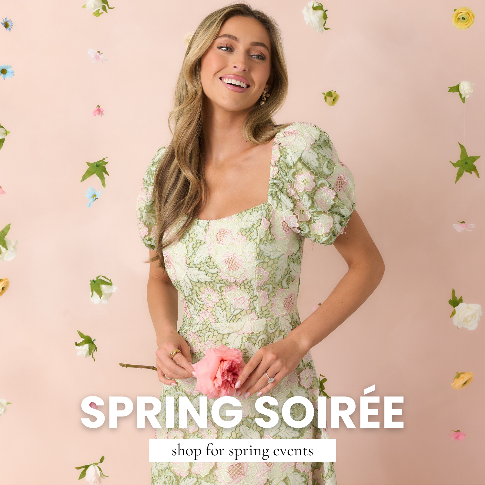 Woman wearing a soft green floral lace dress with puff sleeves while holding a pink flower, surrounded by floating spring blooms against a blush background. This image leads to shop spring event styles from Red Dress.