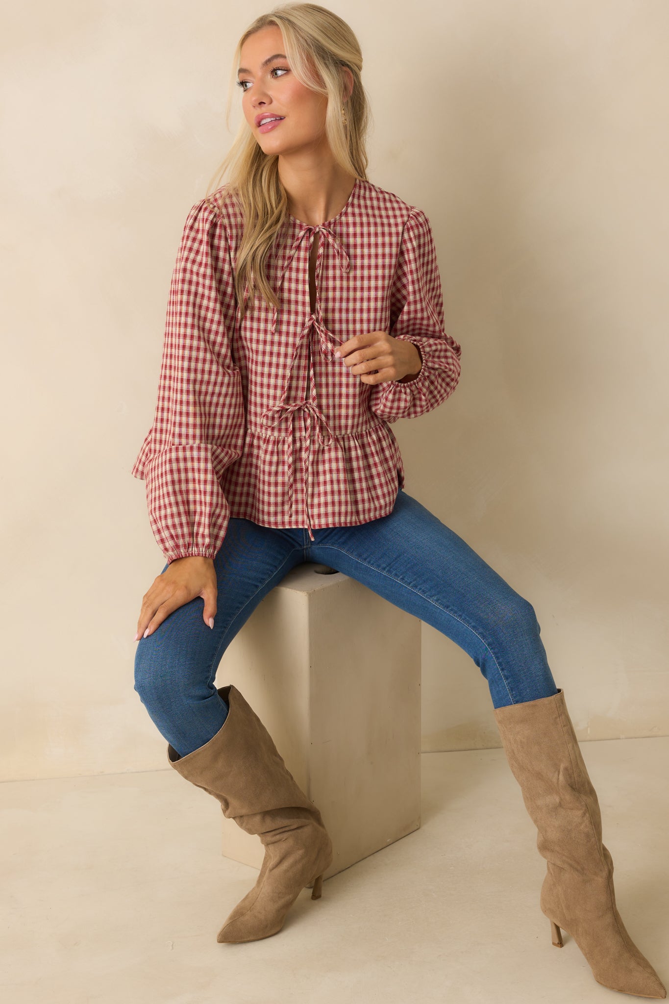 Full front view of red and ivory gingham top with self-tie bow detail and peplum silhouette.