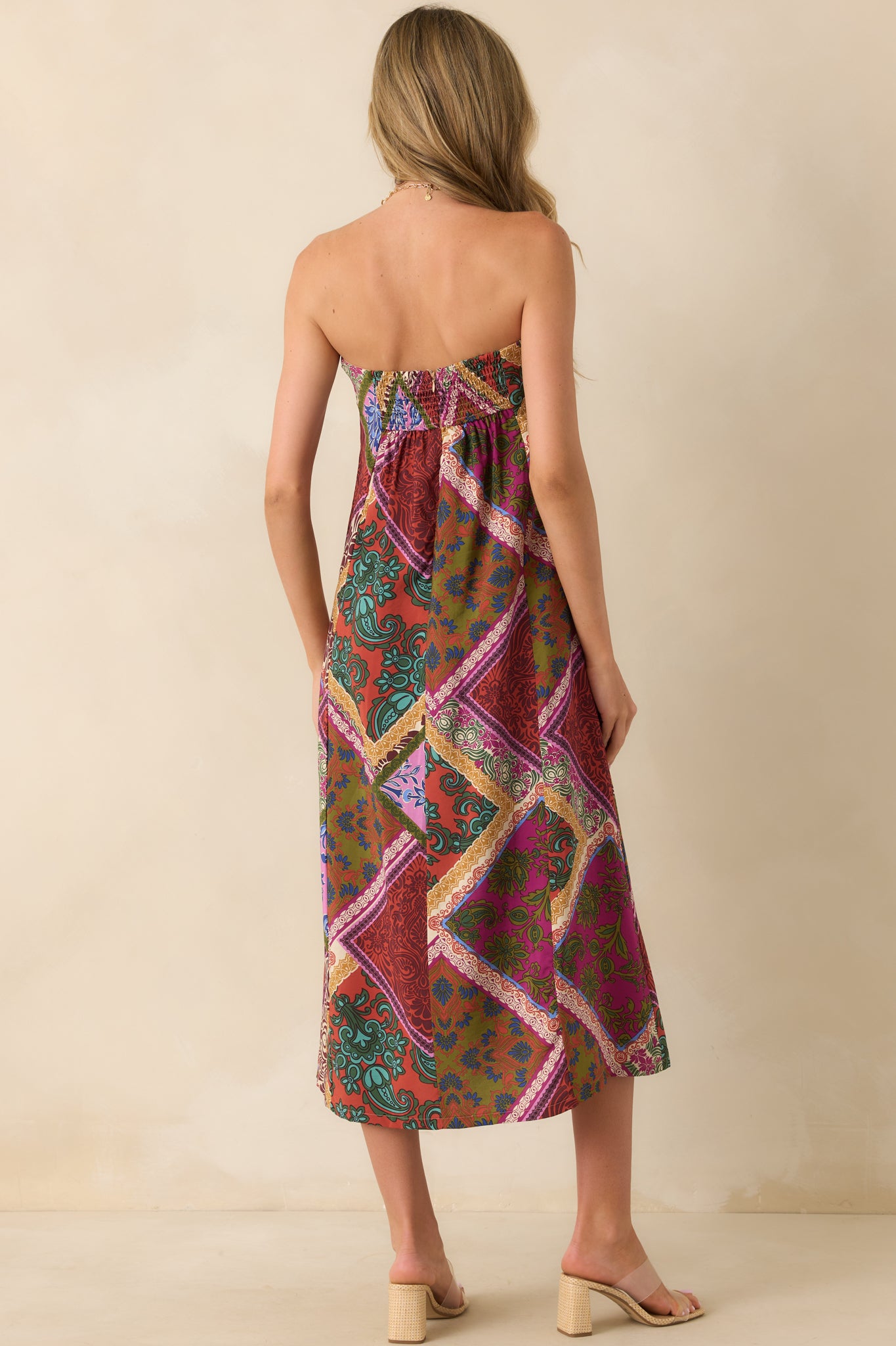 Rear view of the midi dress showing the smocked back panel and hidden back zipper.