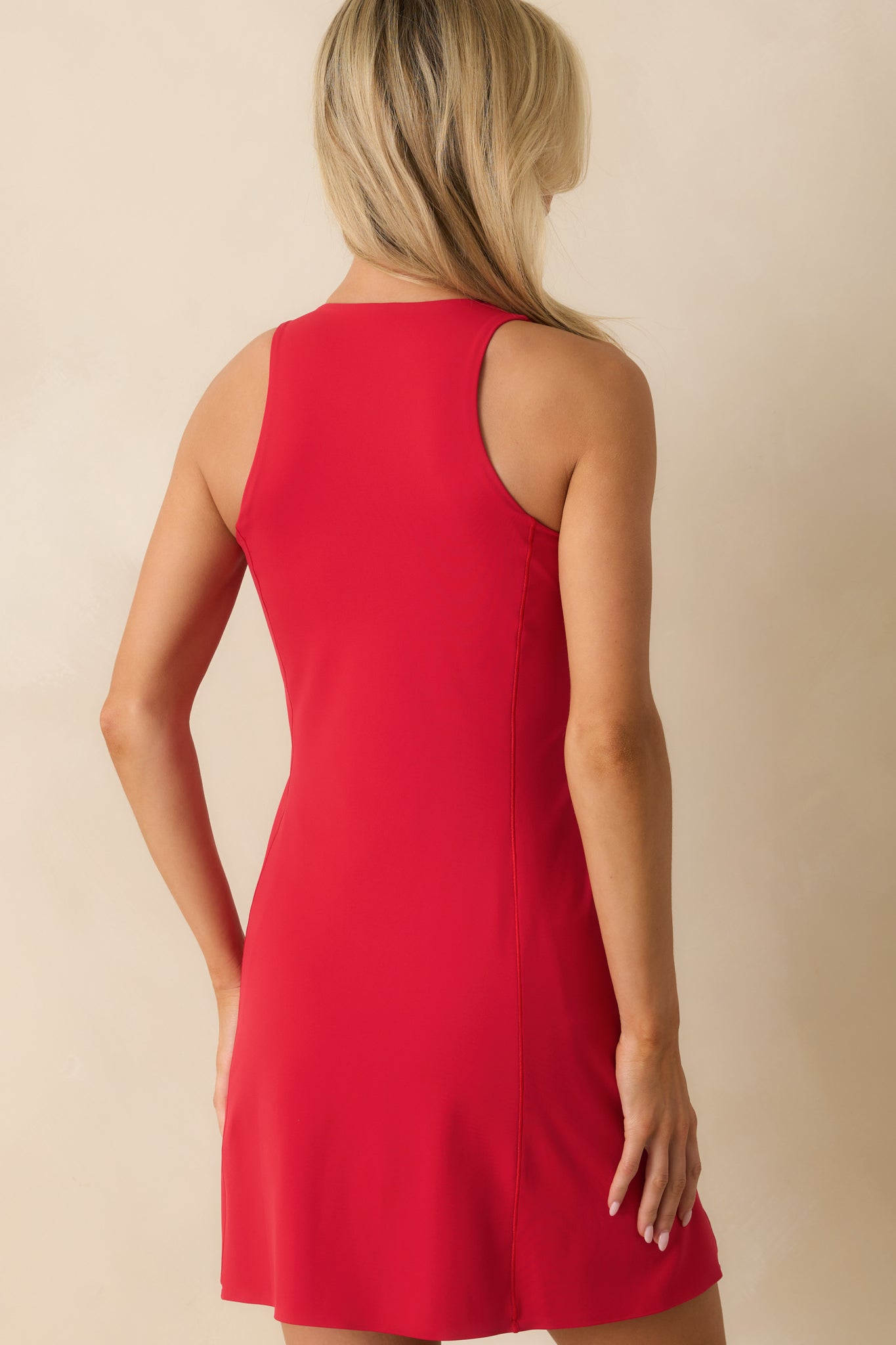 Rear view of red SPANXshape™ mini dress showing smooth fabric and fitted silhouette.