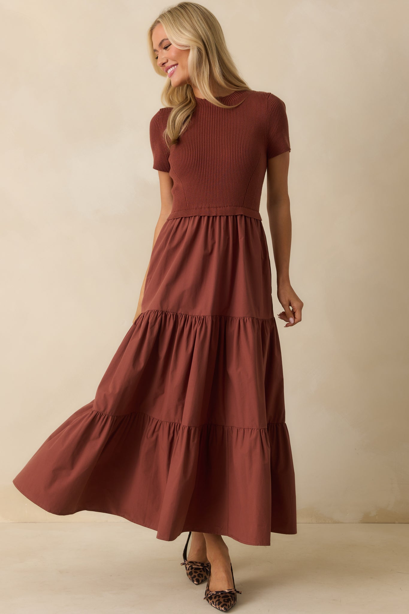 Rust dress with functional pockets, short sleeves, and flowing tiered hem.