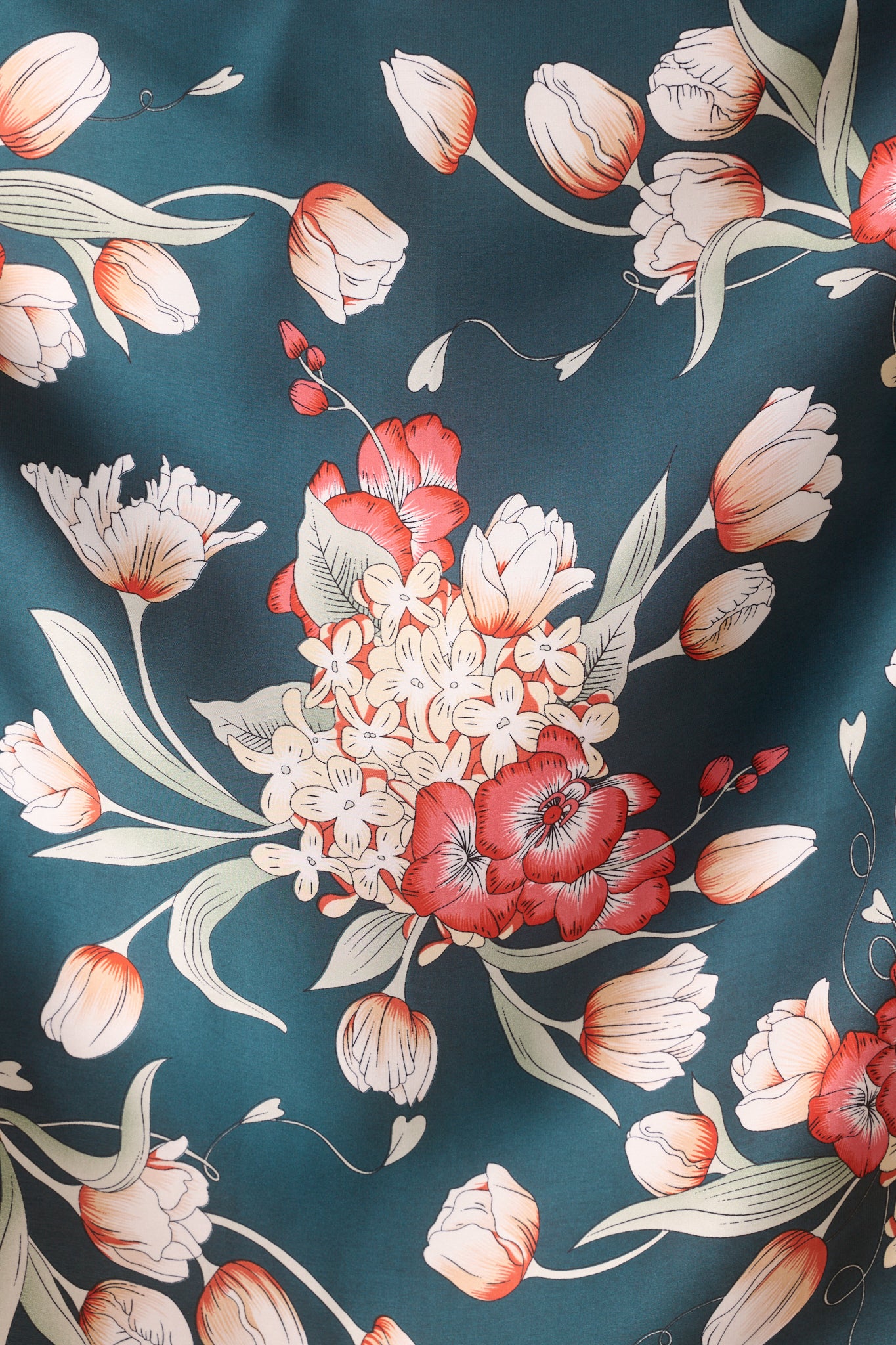Close-up of the scarf’s center, showcasing the detailed red and multicolor floral motifs with the smooth satin fabric visible.