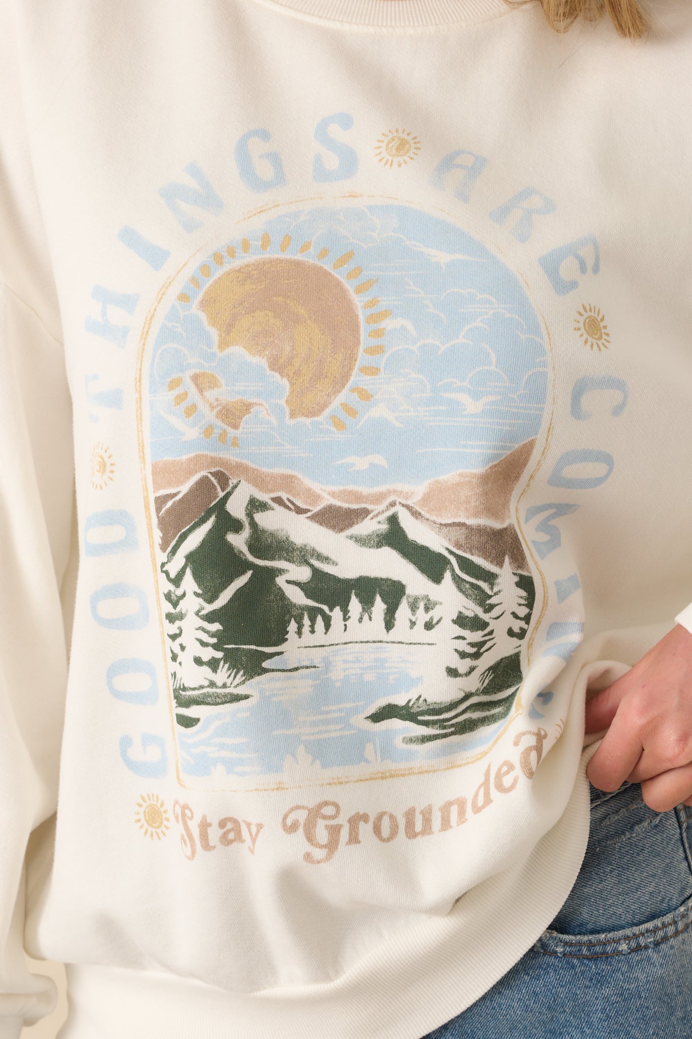 Close-up of screen print graphic showing mountain-lake scene and uplifting text.