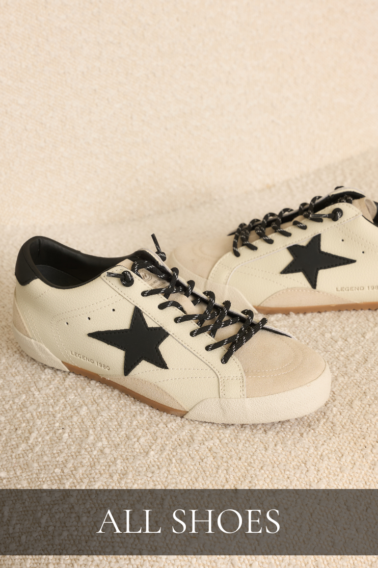Shop all shoes featuring cream sneakers with black star details and black laces