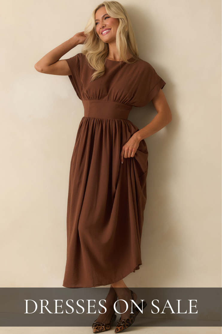 Shop dresses on sale featuring a woman wearing a brown midi dress styled with leopard print heels.