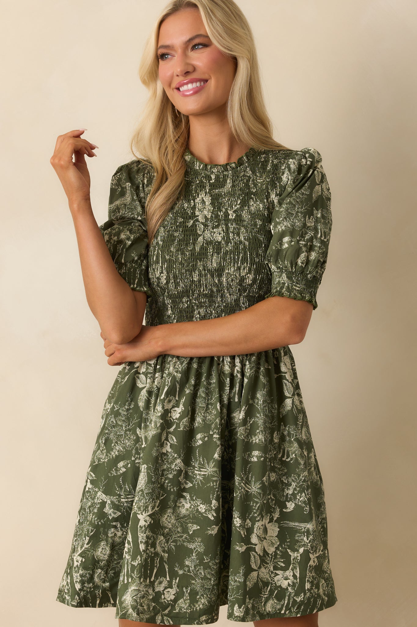 Short puff sleeve with smocked cuff in green toile print.
