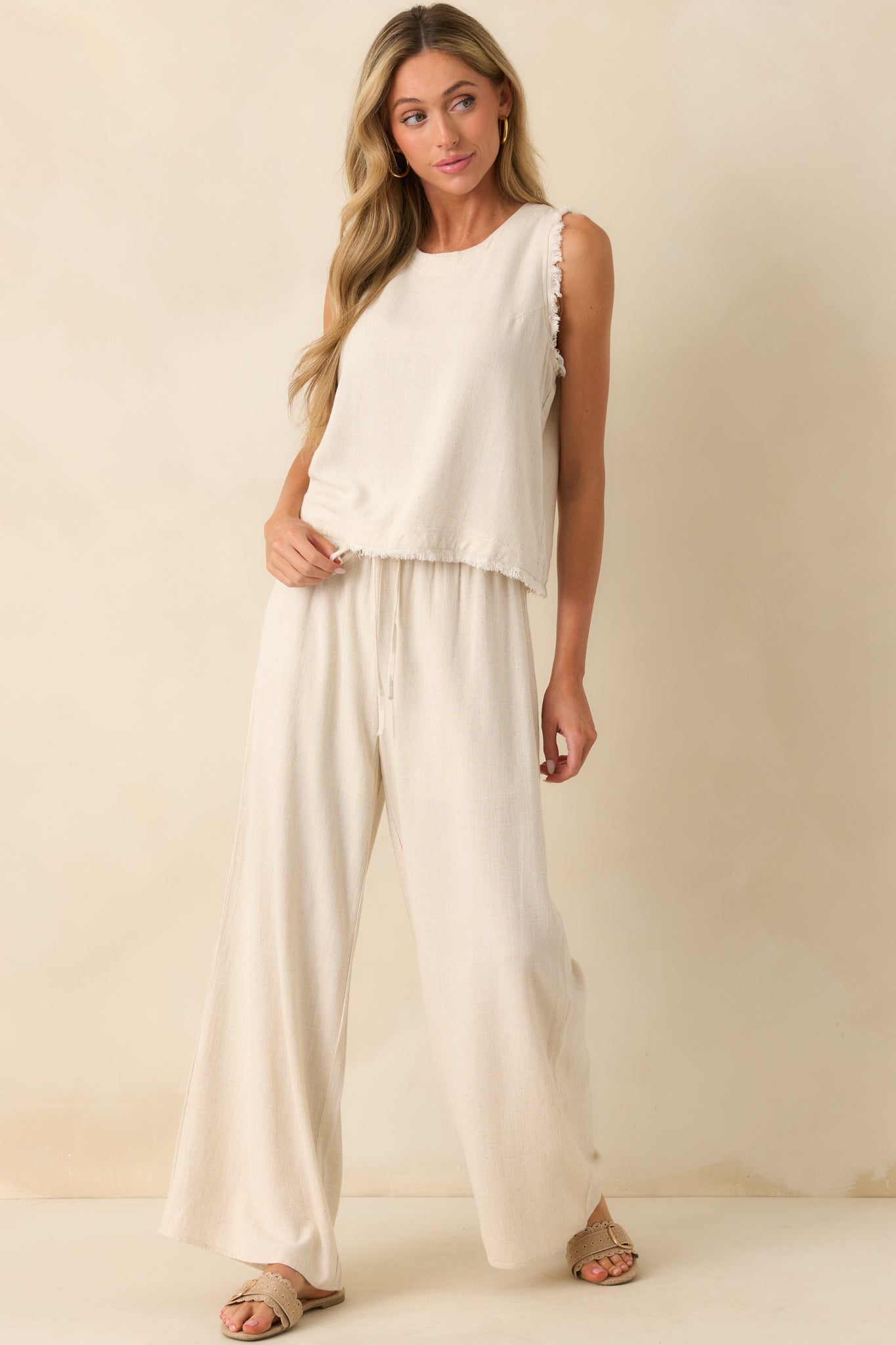 Side angle of the pants showcasing the flowy wide leg and gathered elastic waistband with self-tie detail.