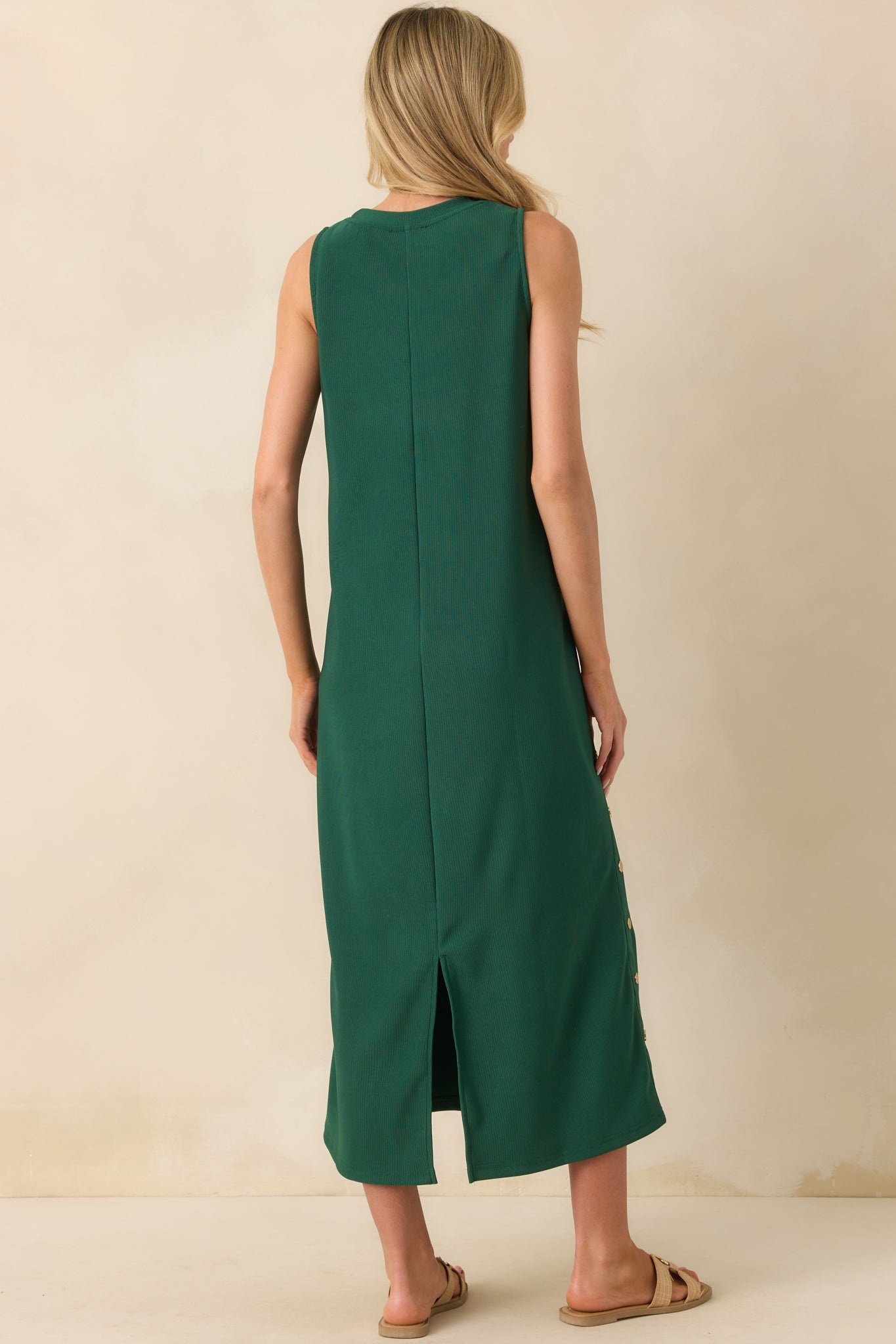Back view of the maxi dress showing the center back seam and back vent slit for ease of movement.